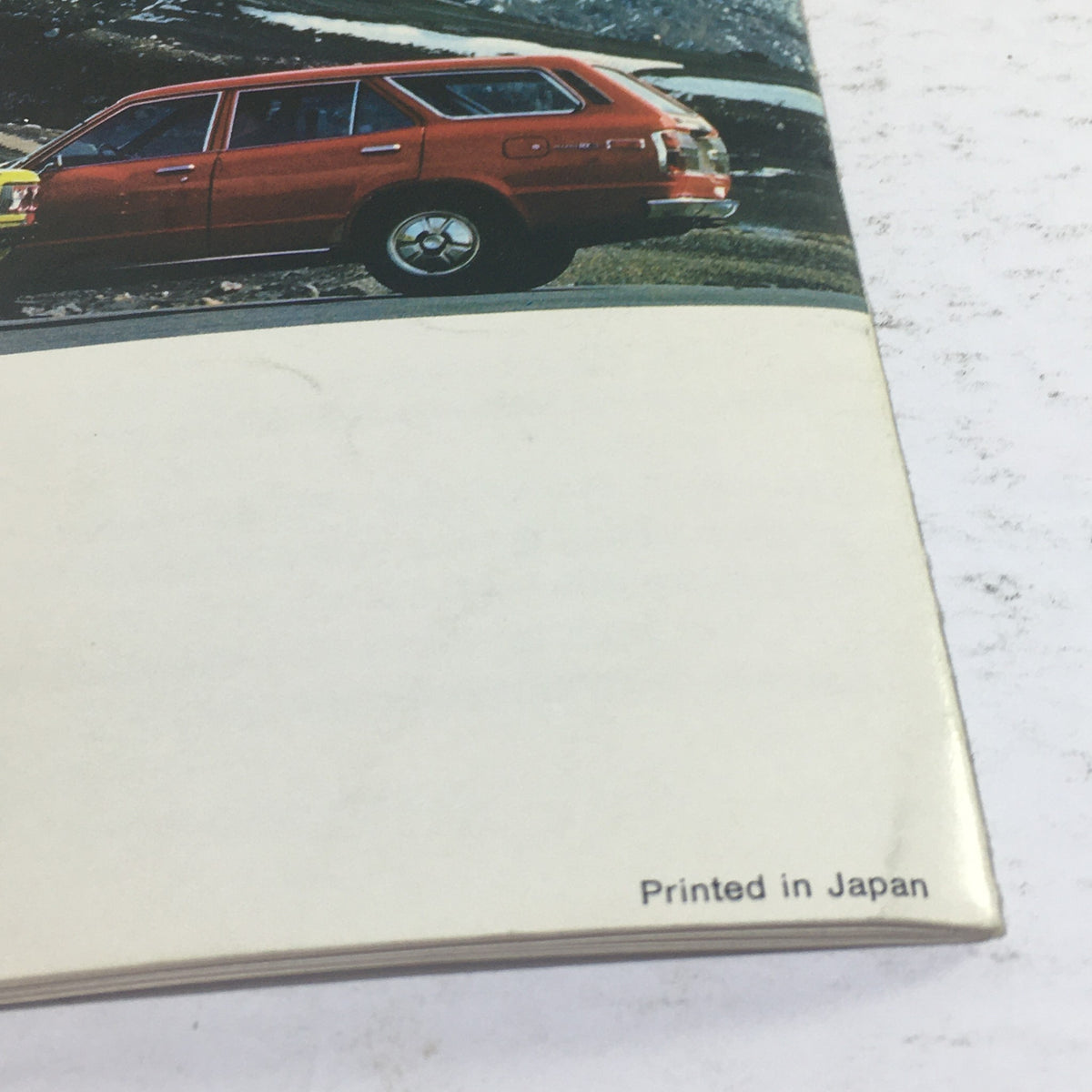 1973 Mazda RX-3 Coupe Sedan Station Wagon Dealership Car Auto Brochure Catalog highlighting the rear view of a red Mazda RX-3 wagon in a natural setting.