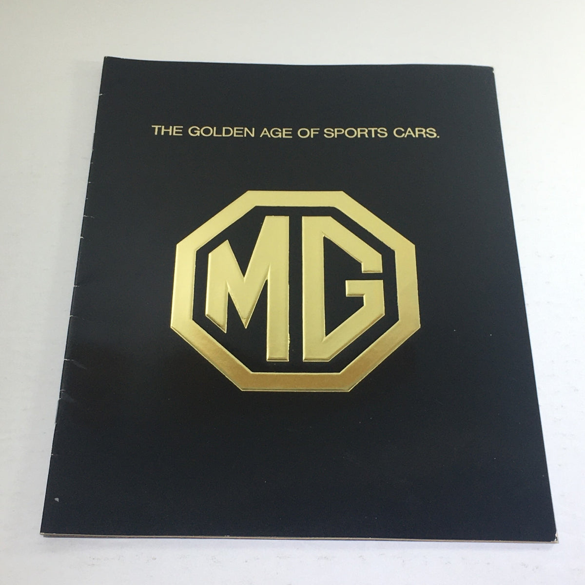 Cover of the 1975 MG Sports Car Dealership Car Auto Brochure Catalog featuring the MG logo and text 'THE GOLDEN AGE OF SPORTS CARS.'