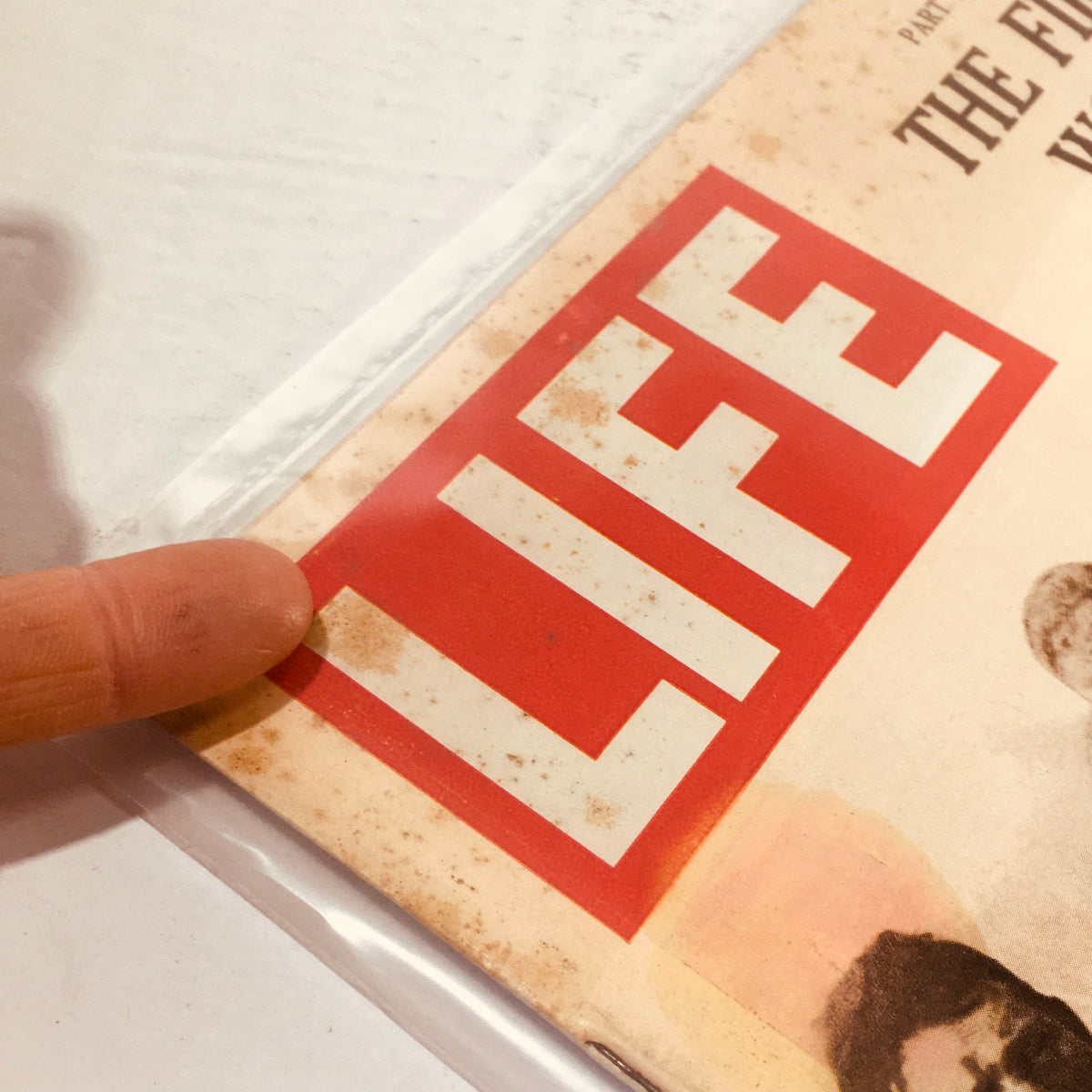 Detail of the top corner of VTG Life Magazine, March 13, 1964, displaying the iconic 'LIFE' logo, with age-related wear indicative of its historical significance.