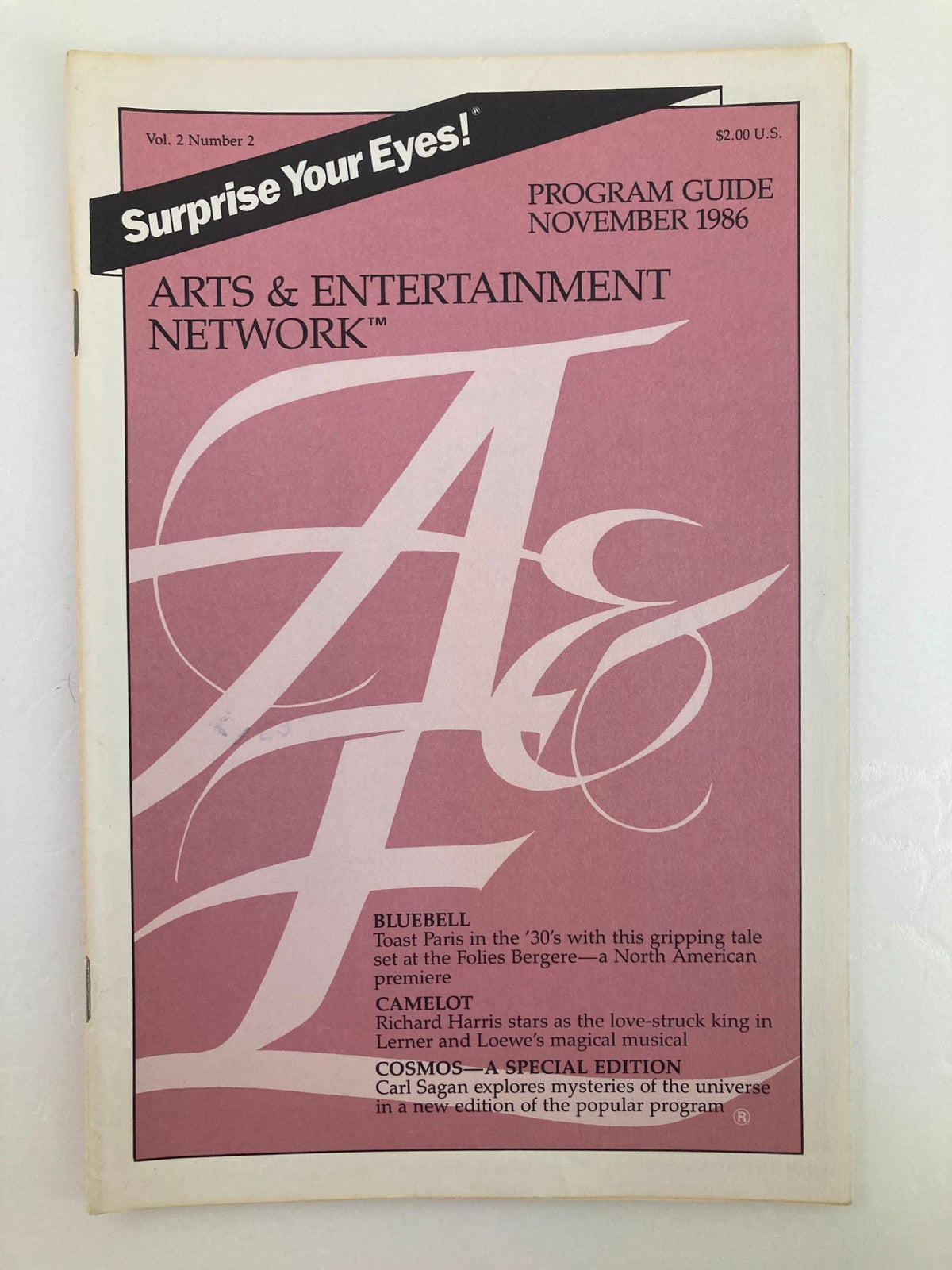 November 1986 Vol 2 #2 Program Guide from the Arts & Entertainment Cable Network featuring programming details and highlights, including shows like Bluebell, Camelot, and Cosmos.