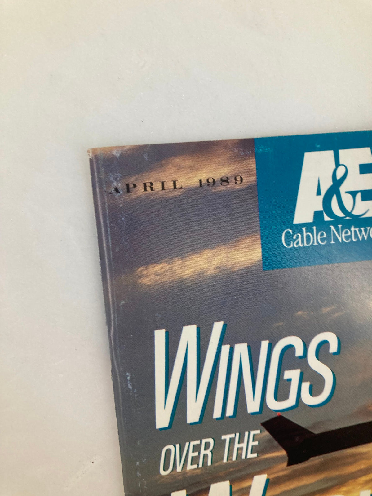 Close-up of the cover of the VTG A&E Cable Network Program Guide April 1989 'Wings Over The World,' displaying the title and publication date.