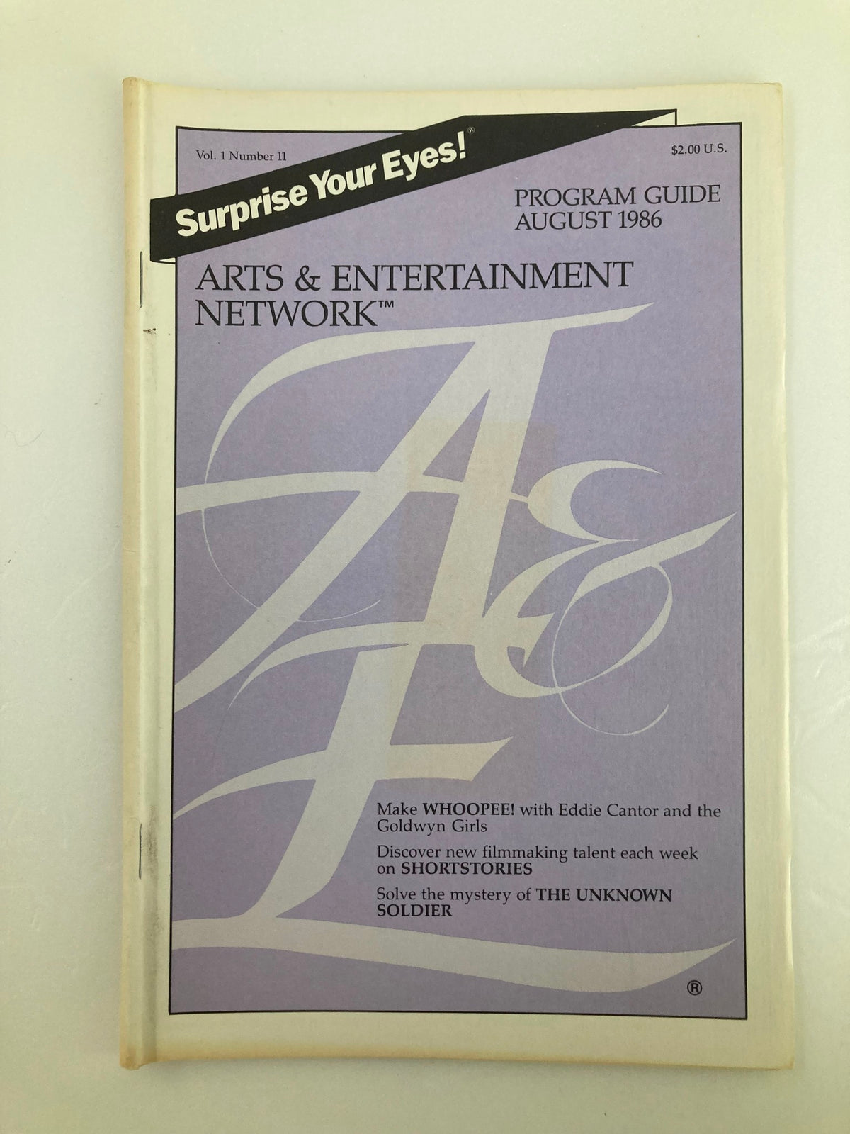 Vintage A&E Cable Network Program Guide from August 1986, Volume 1 Number 11, featuring Eddie Cantor on the cover, showcasing notable television programming and cultural insights from the 1980s.