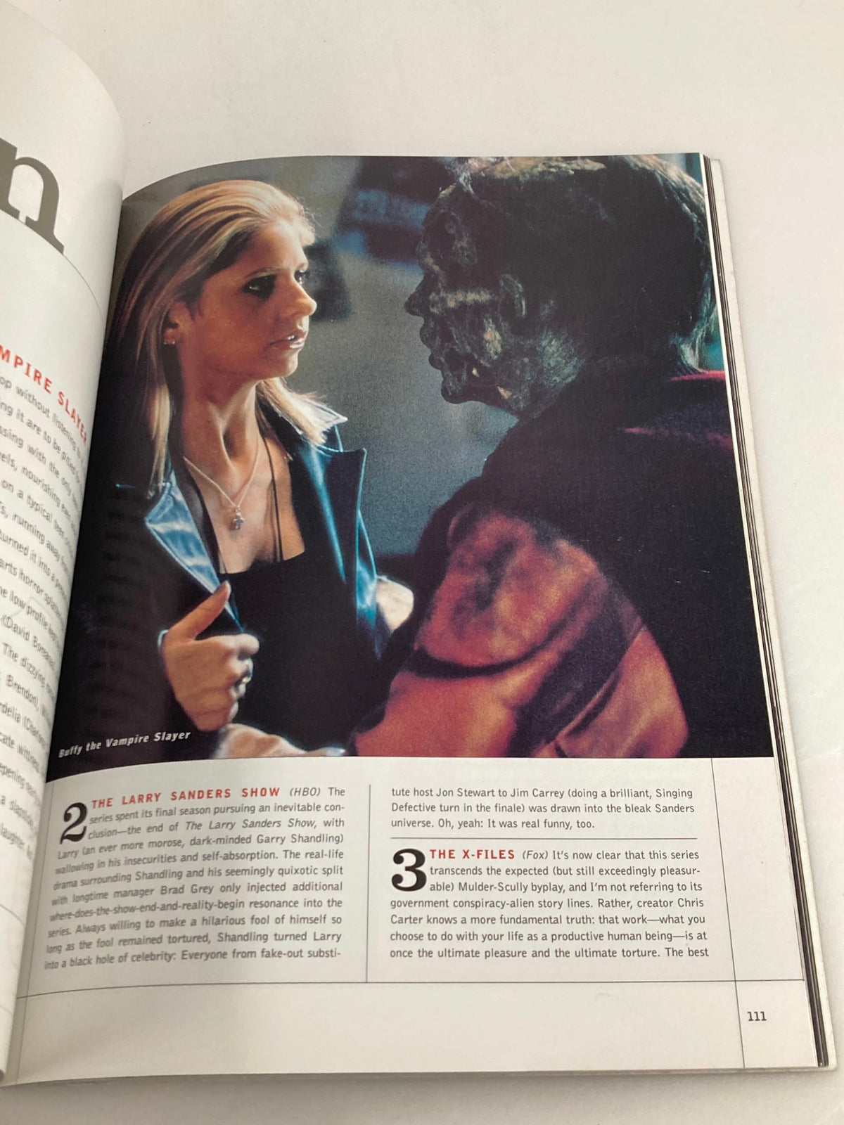Image from VTG Entertainment Weekly Yearbook 1999 depicting a scene from 'Buffy the Vampire Slayer,' featuring the character Buffy facing off against a monster.
