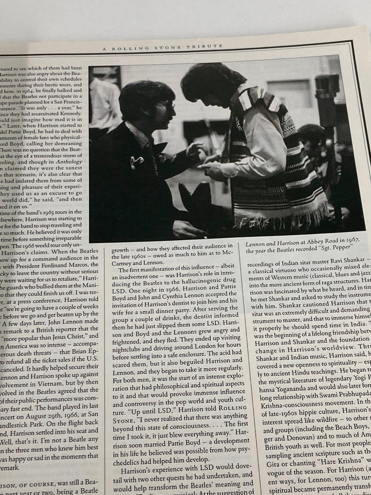 Historical photo of George Harrison interacting with another musician, featured in the Rolling Stone Magazine Special Edition 2001, reflecting on their collaboration and friendship.