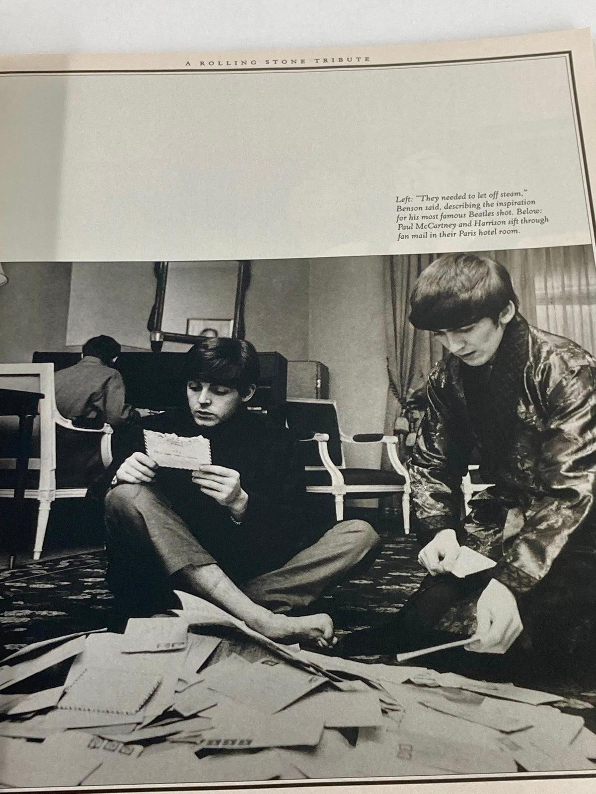 Inside view of Rolling Stone Magazine special edition 2001 featuring George Harrison, showing a black and white photo of two individuals sitting on the floor surrounded by letters, capturing a candid moment.