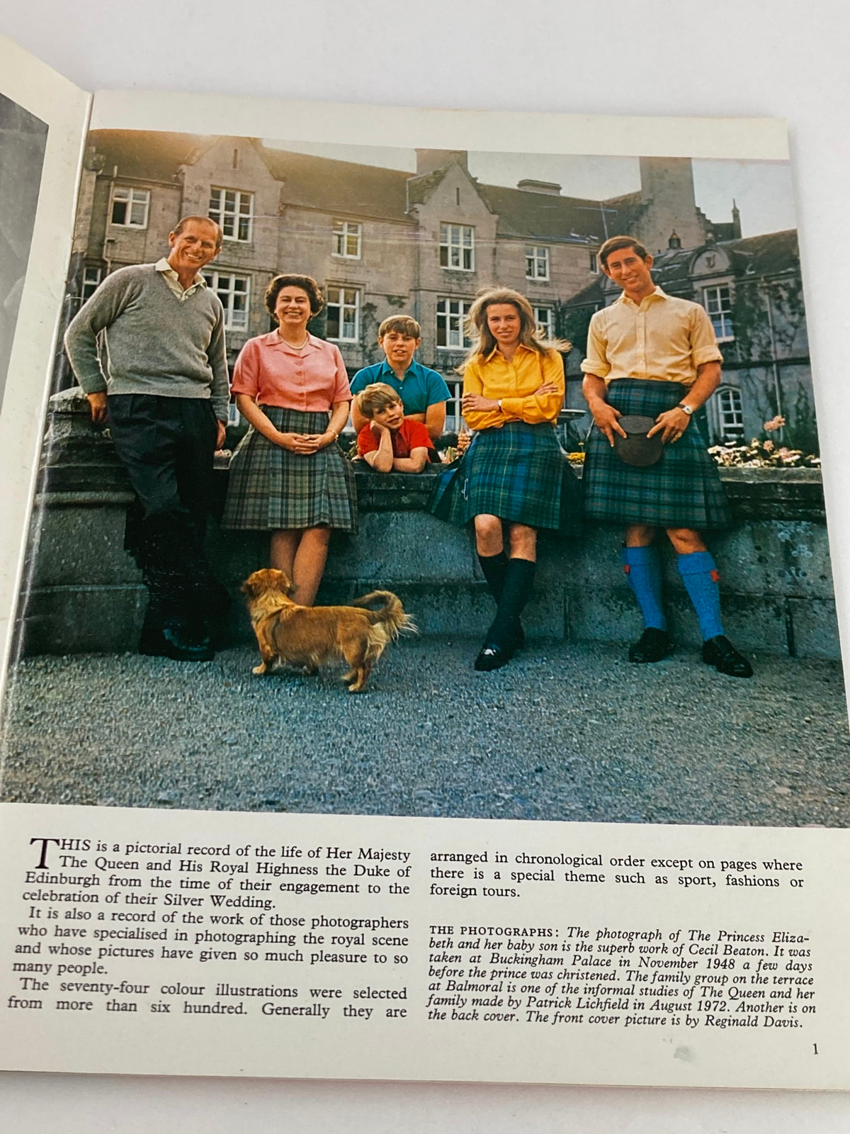 Inside page of the VTG Royal Family Souvenir 1973 Picture Book, displaying a family portrait of Queen Elizabeth II with her family, including Prince Philip and their children in casual clothing.