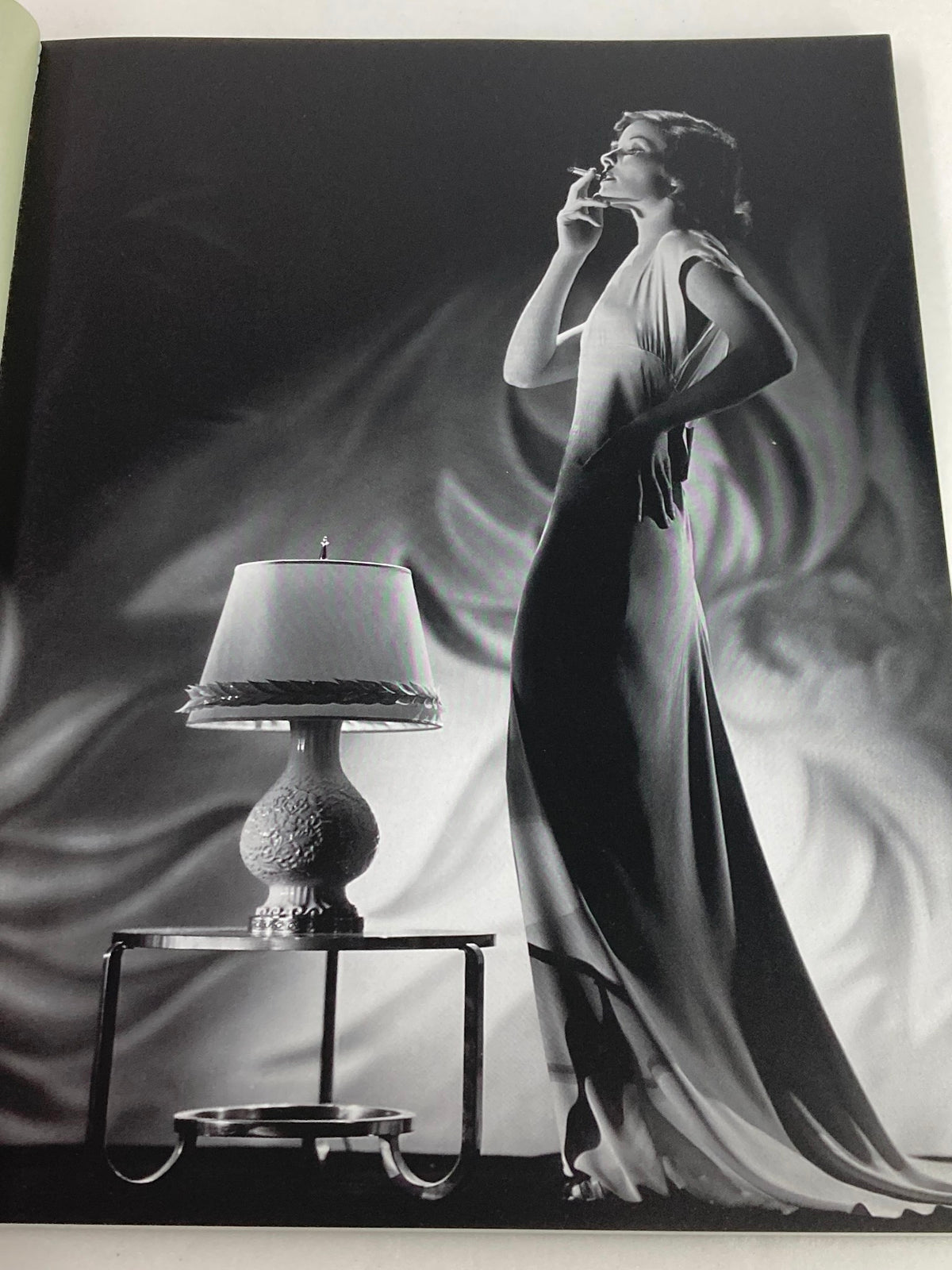 Stylish black and white photograph from People Magazine Tribute Commemorative Issue Katharine Hepburn 1907-2003 featuring a model posing elegantly beside a lamp, showcasing classic 1930s fashion.