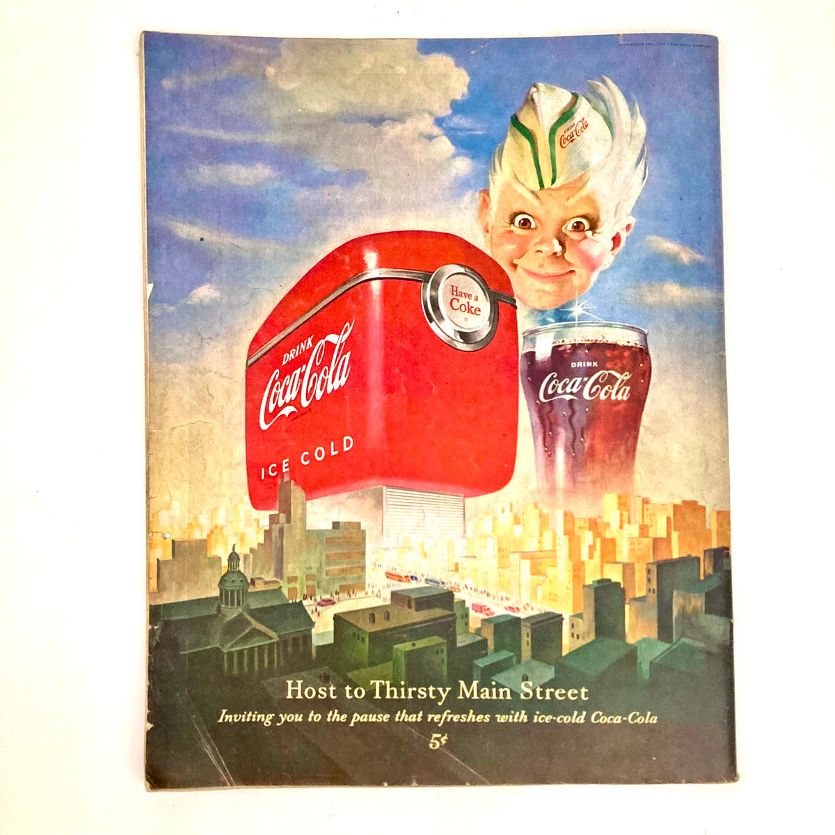 Saturday Evening Post Magazine cover from November 4, 1950, featuring an illustrated Coca-Cola advertisement with a playful character and iconic red cooler in an urban setting.
