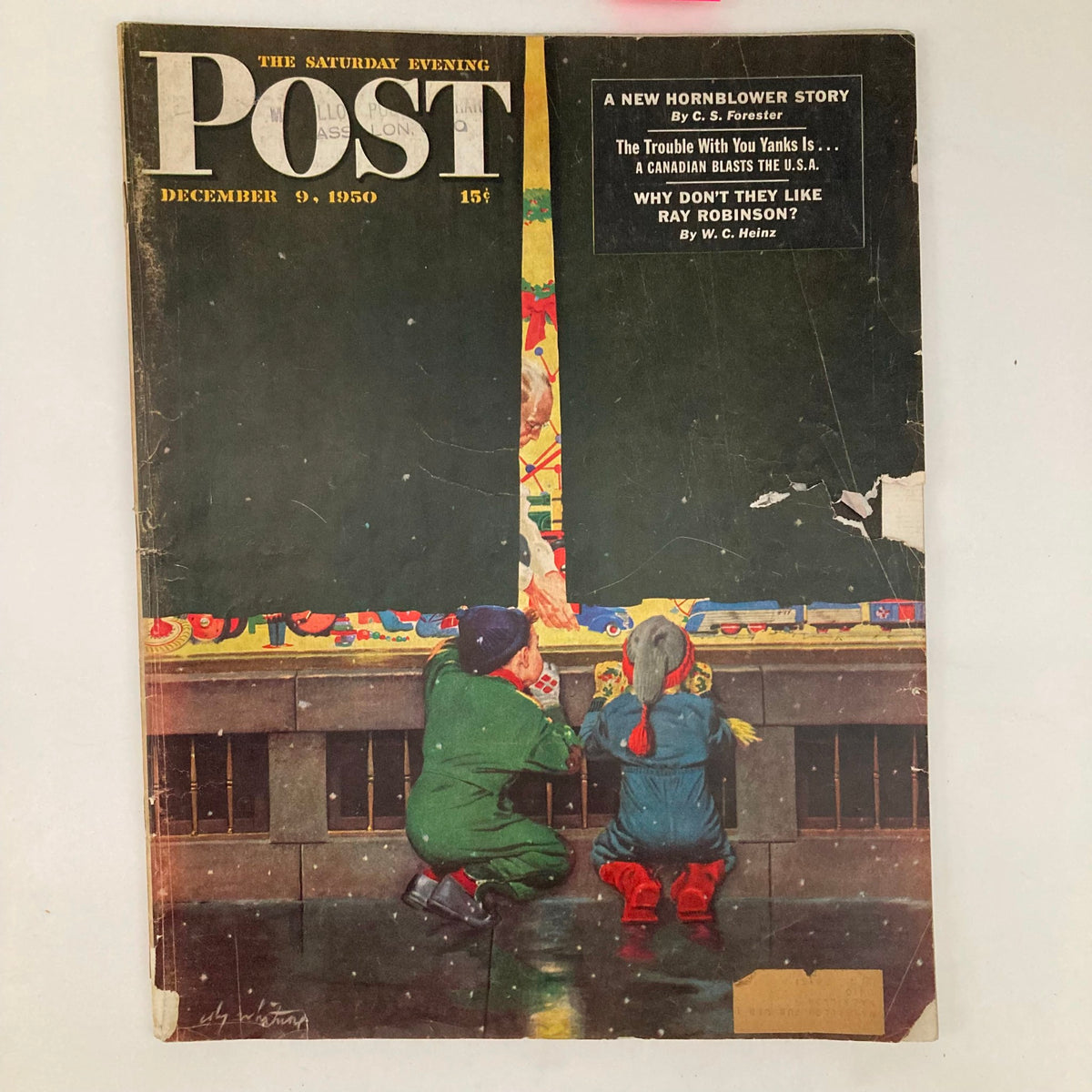 Cover of the Saturday Evening Post Magazine from December 9, 1950, featuring children looking at a vibrant holiday display, illustrated by Coby Whitmore.