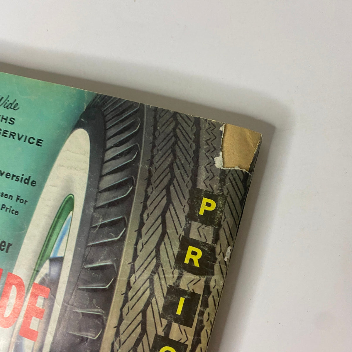 Close-up of the vintage 1961 Montgomery Ward Summer Catalog cover showing a tire advertisement with pricing details. The catalog illustrates mid-20th century American retail design, highlighting the unique aesthetic of 1960s magazine layouts.