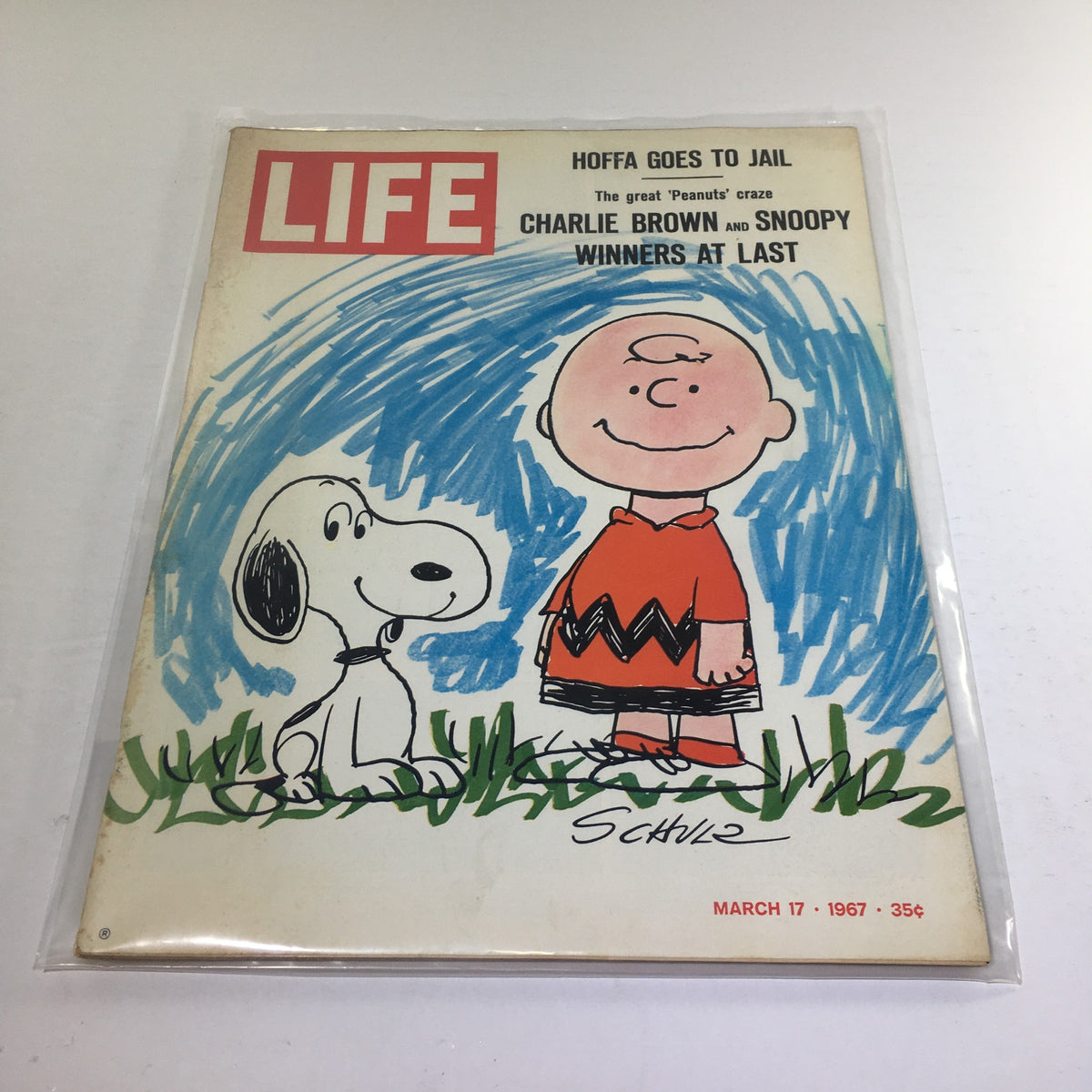 Vintage Life Magazine from March 17, 1967, featuring Charlie Brown and Snoopy on the cover. The illustration includes Charlie Brown smiling beside Snoopy with a bright blue background, showcasing nostalgic cartoon art.