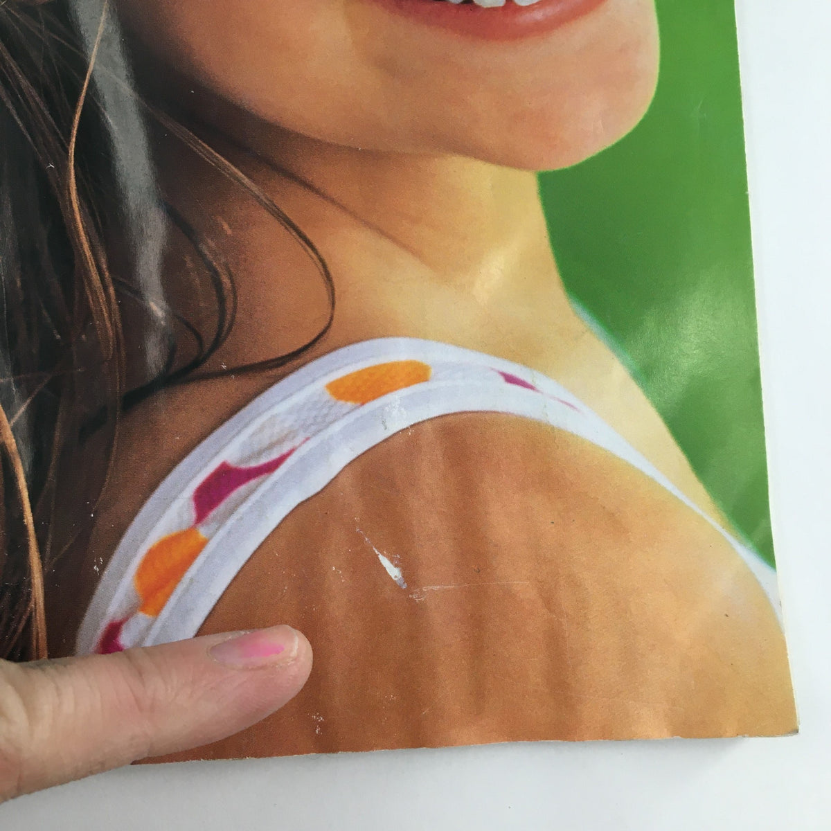 Close-up of a smiling girl on the cover of American Girl Magazine July August 1997, highlighting her summer-themed outfit and joyful expression.