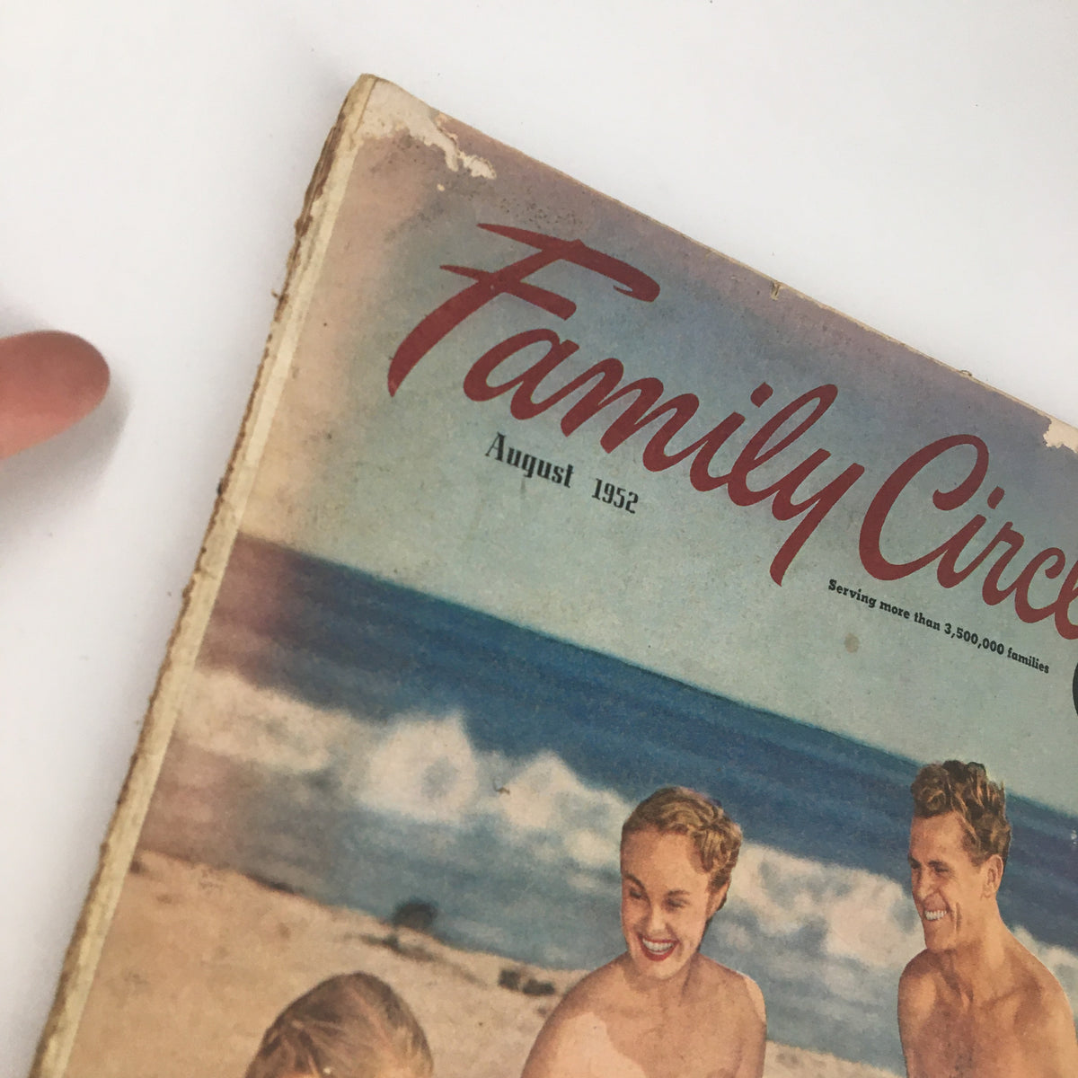 Cover of the VTG Family Circle Magazine from August 1952 featuring colorful beach imagery and a joyful family scene. Perfect for vintage magazine collectors.