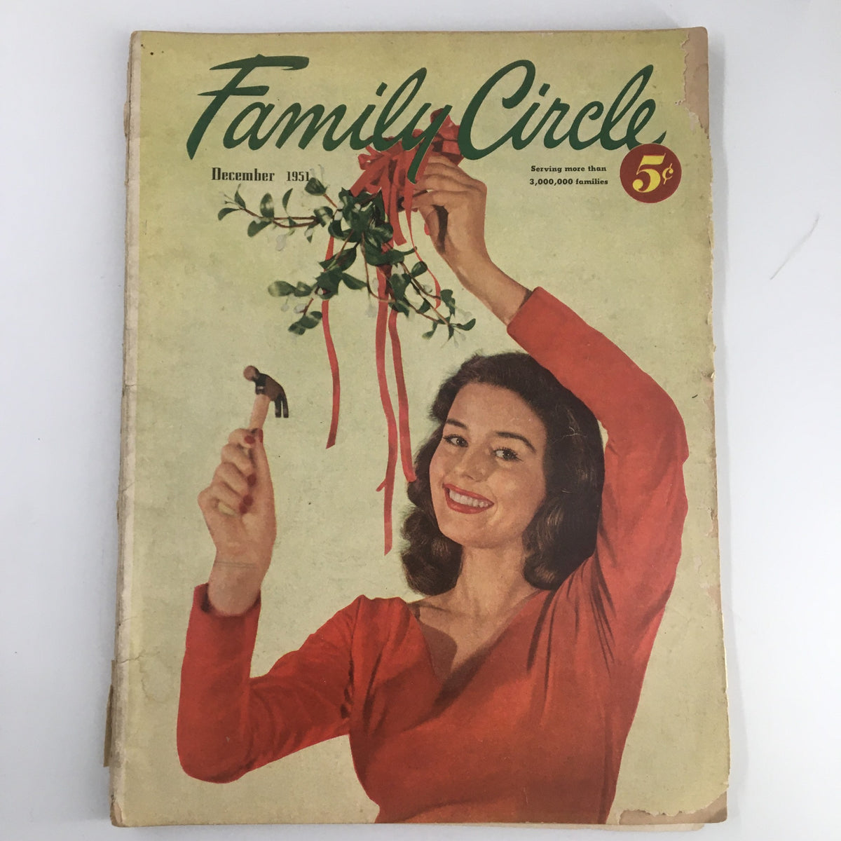 Vintage Family Circle Magazine from December 1951 featuring a woman cheerfully holding mistletoe with red ribbons, titled 'VTG Family Circle Magazine December 1951 Make A Cinnamon-Fruit Twist No Label.'