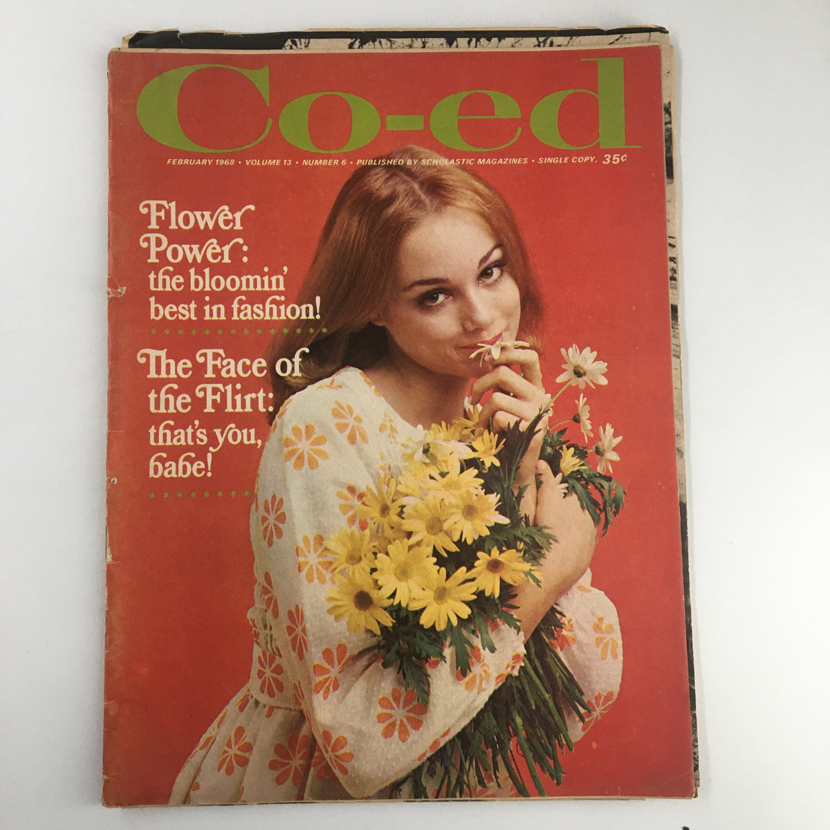 Cover of the VTG Co-Ed Magazine from February 1968 featuring the title 'Flower Power: The Bloomin' Best Fashion,' showcasing a young woman holding flowers with a bright red background.