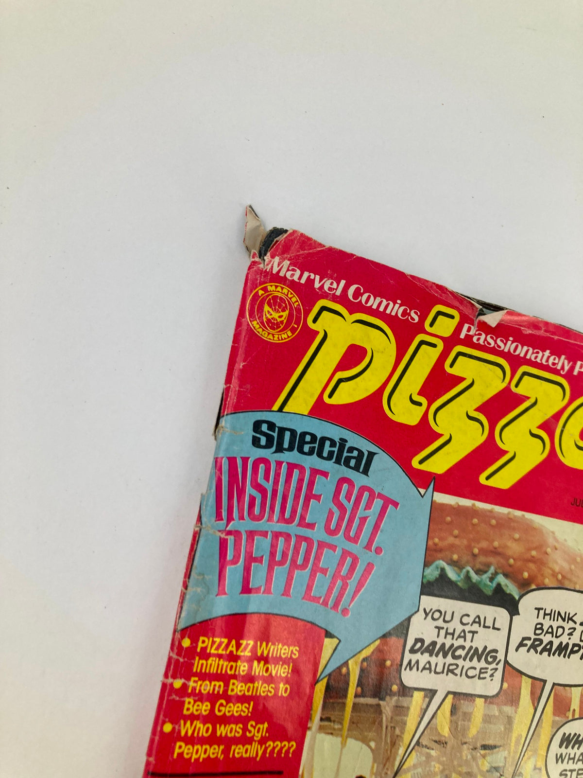 Close-up of VTG Marvel Comics Pizzazz Issue 10 July 1978 showing the top corner with wear, emphasizing its vintage condition. The magazine features 'Special Inside Sgt. Pepper' text and colorful imagery related to the 1970s.