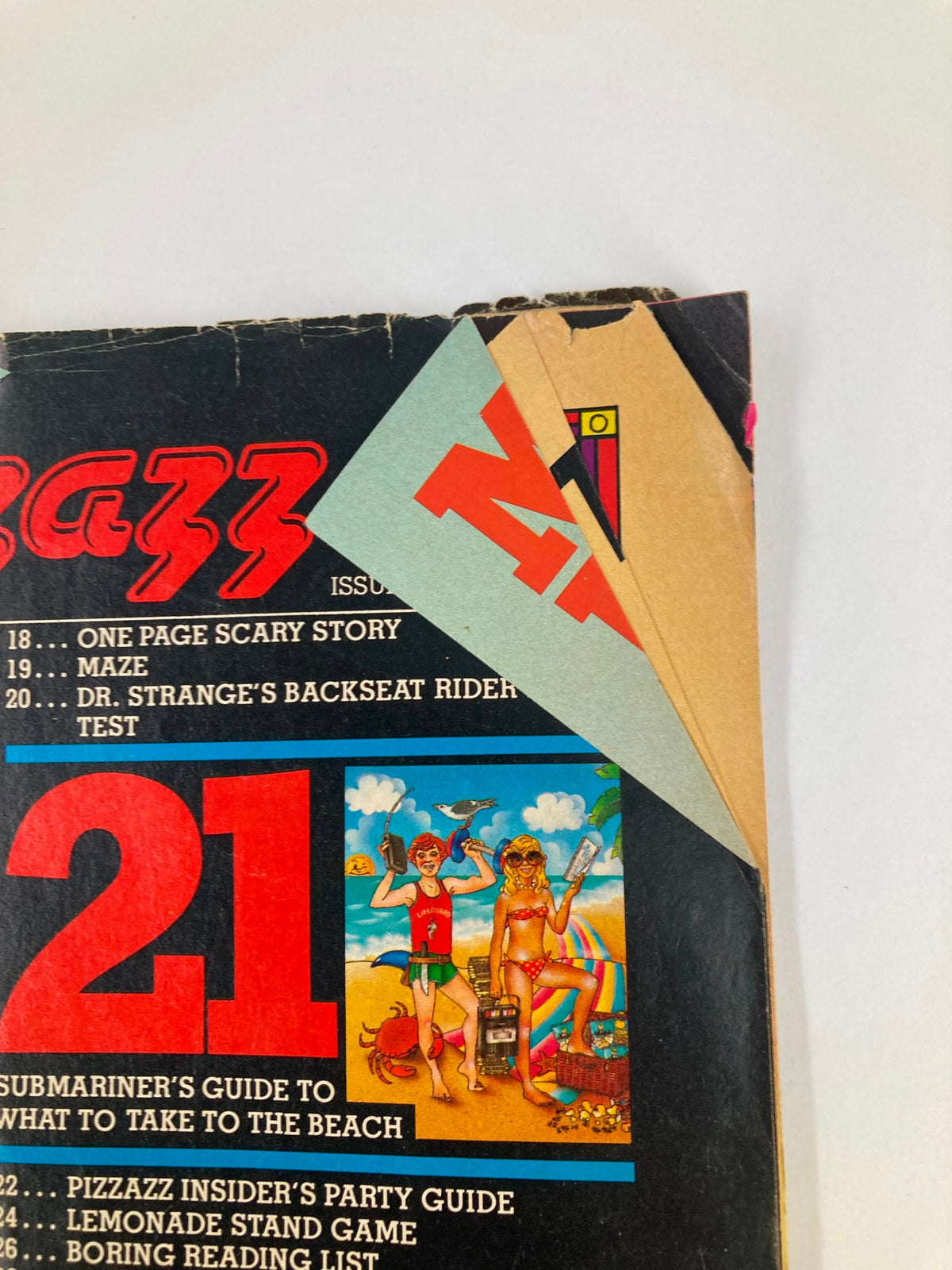 Back cover of VTG Marvel Comics Pizzazz Issue 10 July 1978 featuring colorful illustrations and a partially torn page. No Label.
