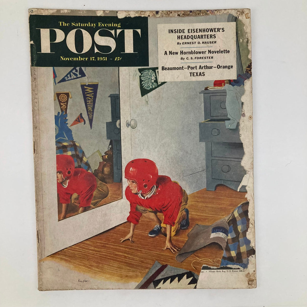Cover of the Saturday Evening Post November 17, 1951, featuring a young boy in a red helmet crawling in front of a mirror, showcasing mid-century Americana art.