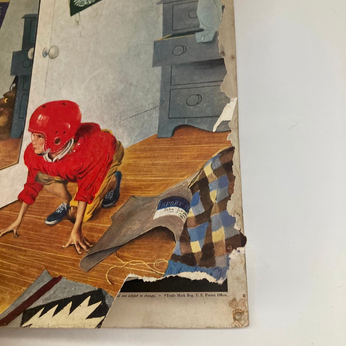 Close-up view of the Saturday Evening Post cover from November 17, 1951, highlighting a young boy in a red helmet and the wear on the magazine's edges.