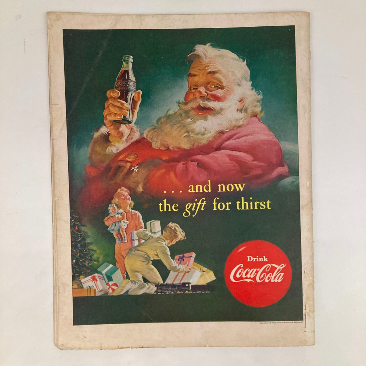 Vintage Coca-Cola advertisement featuring Santa Claus, titled 'Saturday Evening Post Magazine November 29 1952', showcasing a festive scene with children and Christmas gifts, promoting Coca-Cola as the 'gift for thirst'.