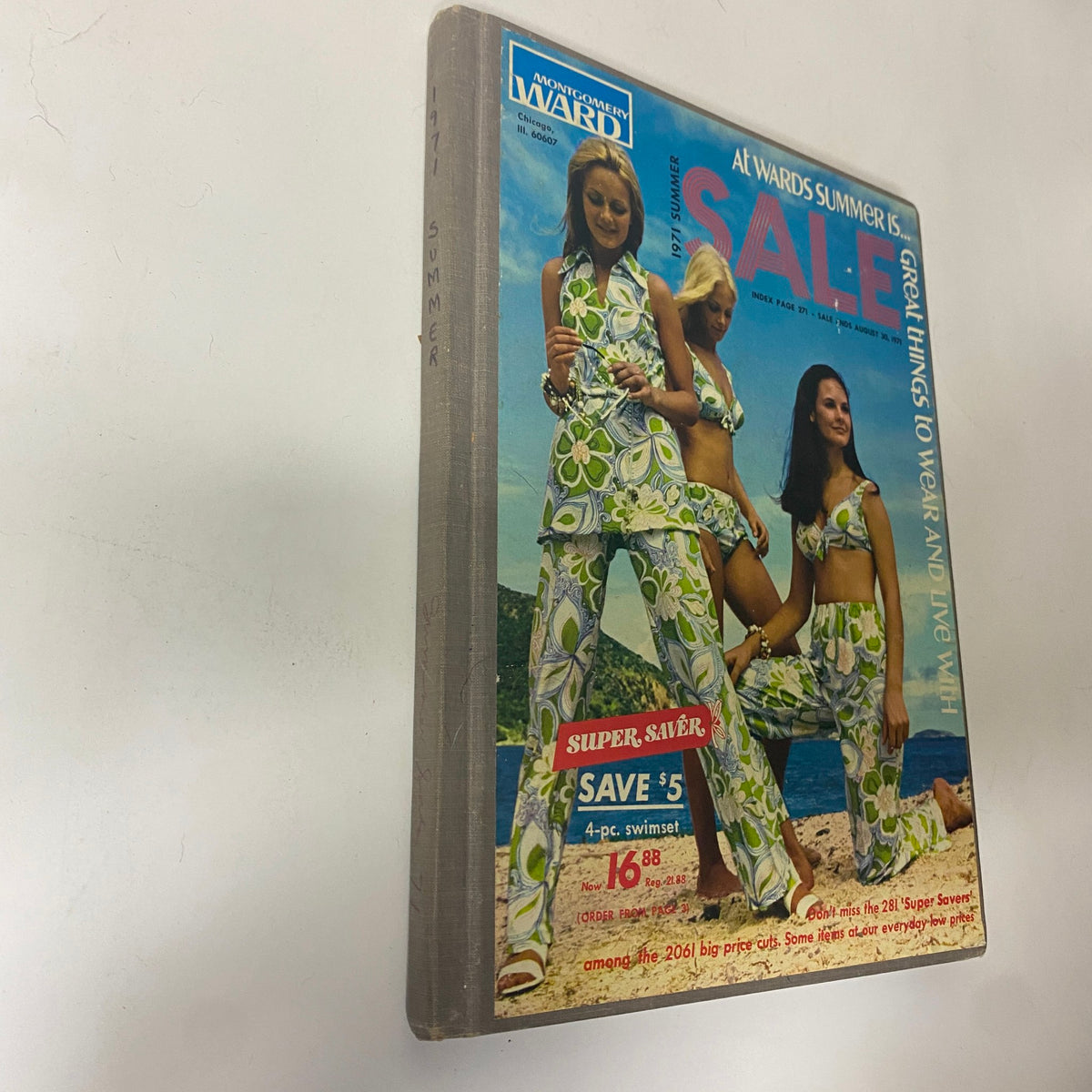 Side view of the 1971 Montgomery Ward Summer Catalog cover, showcasing the title and promotional sale details with models in summer attire.