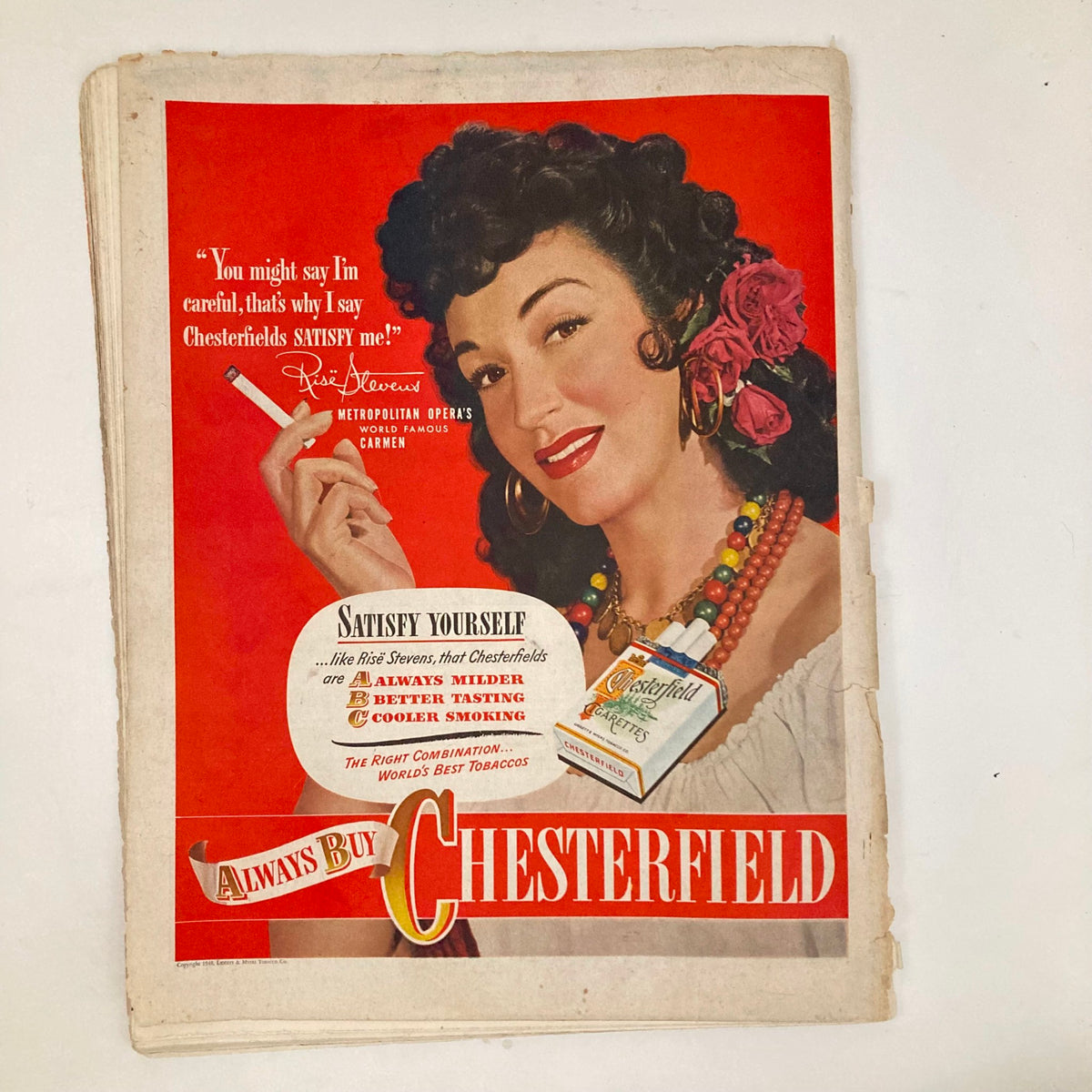 Vintage advertisement featuring a woman with flowers holding a Chesterfield cigarette from the January 17, 1948 Saturday Evening Post magazine, promoting the brand's smoothness and quality.
