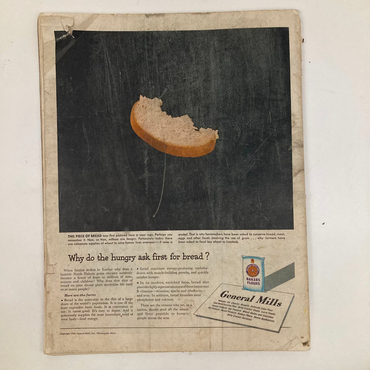 Back cover of the Saturday Evening Post Magazine February 7 1948, featuring an advertisement by General Mills discussing bread and hunger, accompanied by a visual of a bitten piece of bread.