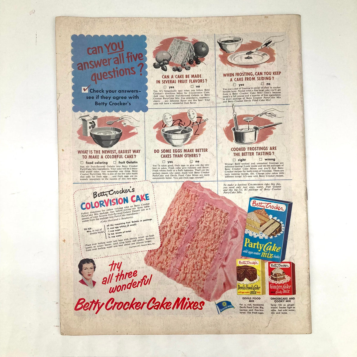Back cover of Saturday Evening Post Magazine January 5 1952 featuring an advertisement for Betty Crocker's Colorvision Cake, including eye-catching graphics and questions related to cake baking.