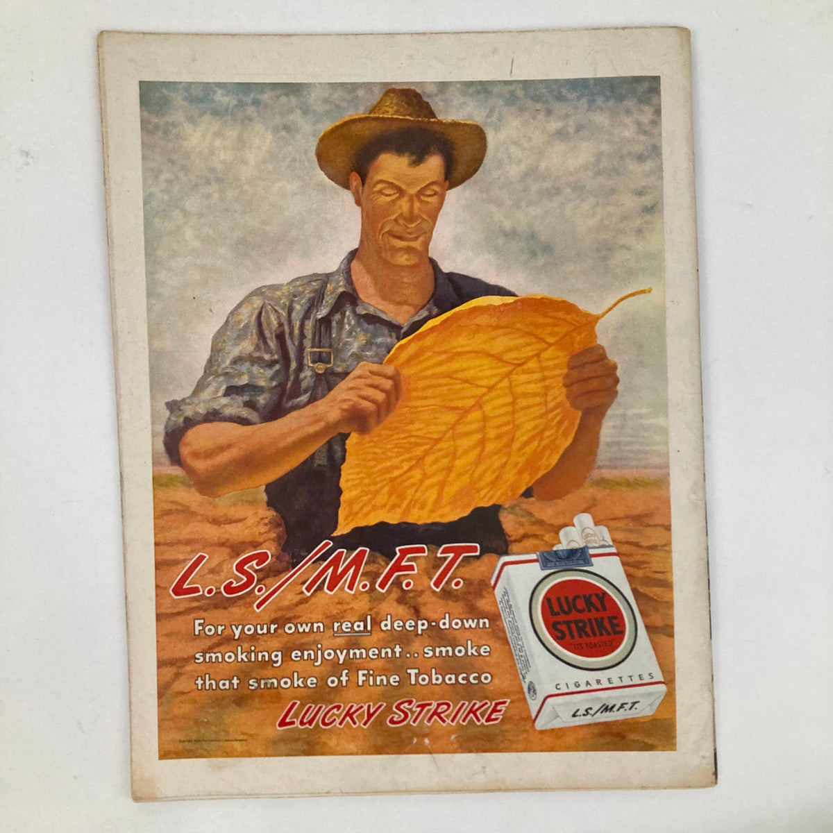 Vintage advertisement in the Saturday Evening Post Magazine April 13 1946 for Lucky Strike cigarettes, featuring a farmer holding a tobacco leaf, emphasizing traditional American tobacco farming.