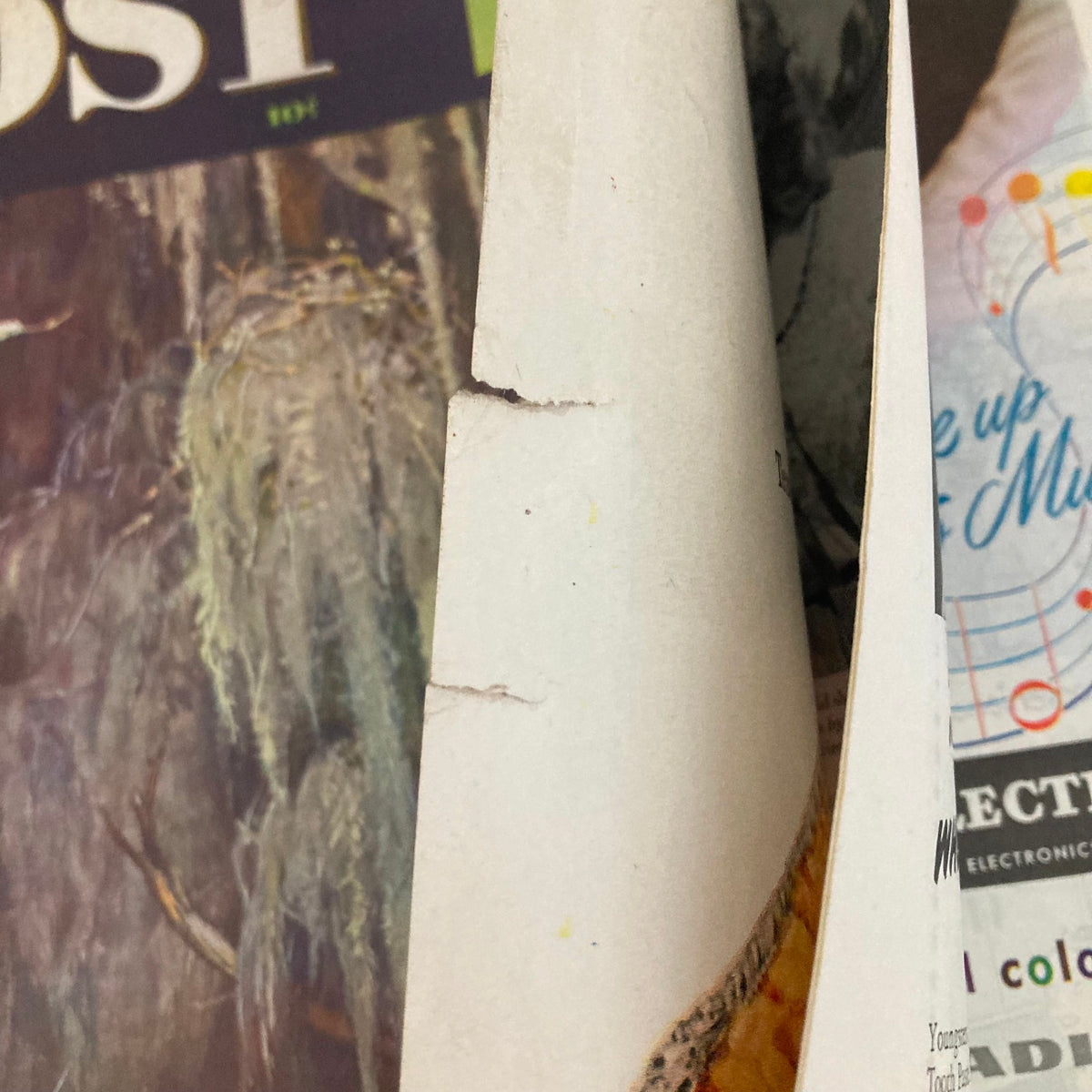 Close-up view of the edge of the Saturday Evening Post Magazine April 5, 1947 showing slight wear and tear on the pages, preserving the vintage character.