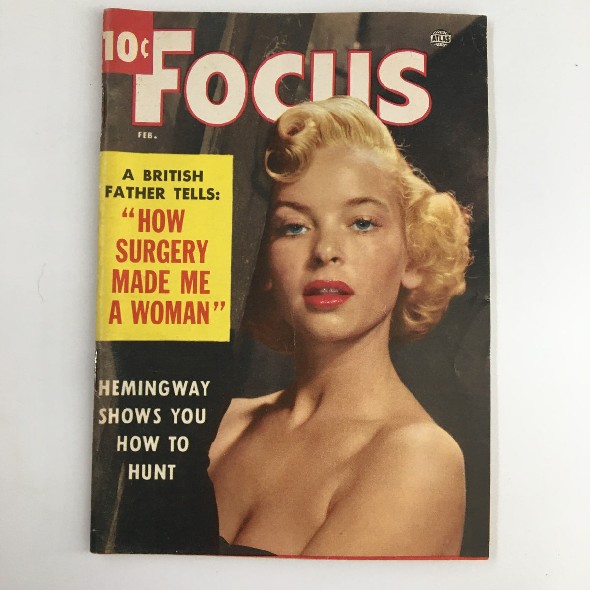 Cover of VTG Focus Magazine February 1955 featuring Hemingway Shows You How To Hunt, showcasing a vintage model with curly blonde hair and bold red lipstick.