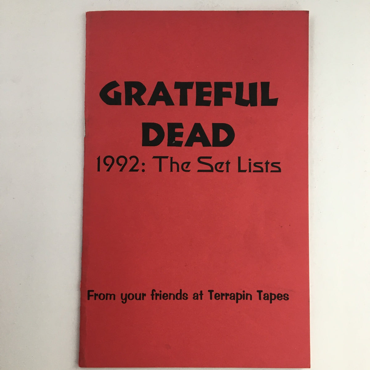 Cover of 'Grateful Dead 1992: The Set Lists From Your Friends at Terrapin Tapes' featuring bold black text on a vibrant red background.