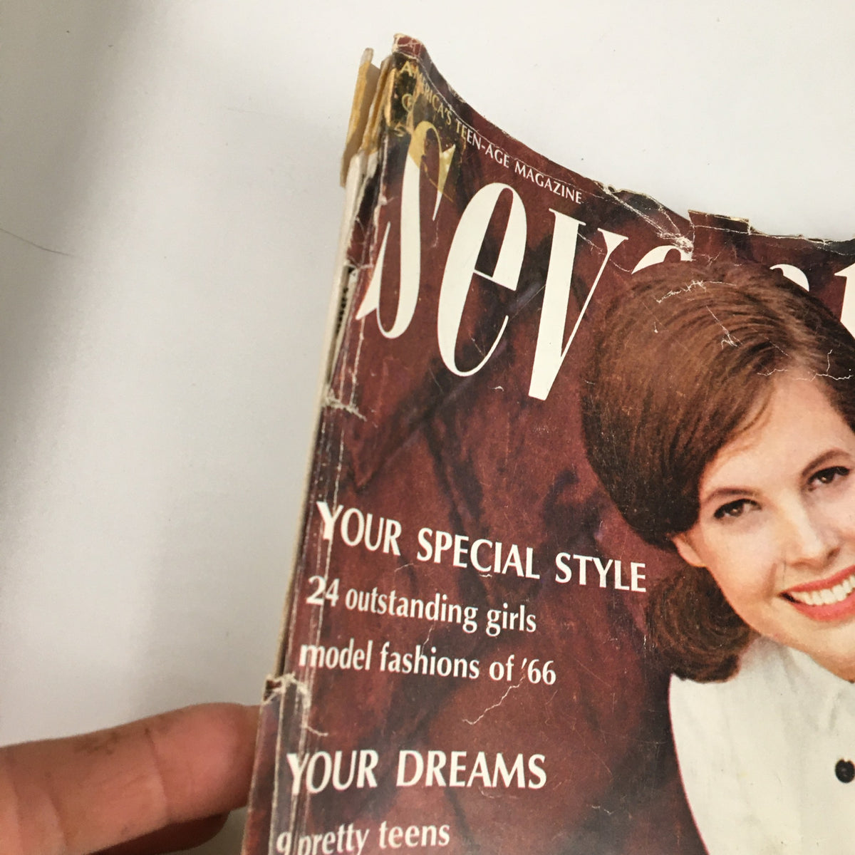 Close-up of the cover of VTG Seventeen Magazine January 1966 featuring the title 'Seventeen' and a smiling model showcasing 1960s fashion.