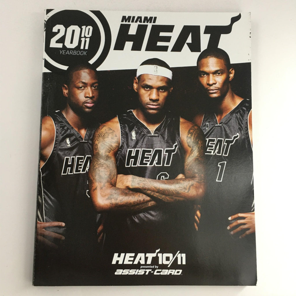 Miami Heat 2010-2011 Yearbook featuring LeBron James, Dwyane Wade, and Chris Bosh, showcasing top NBA talent in excellent condition.