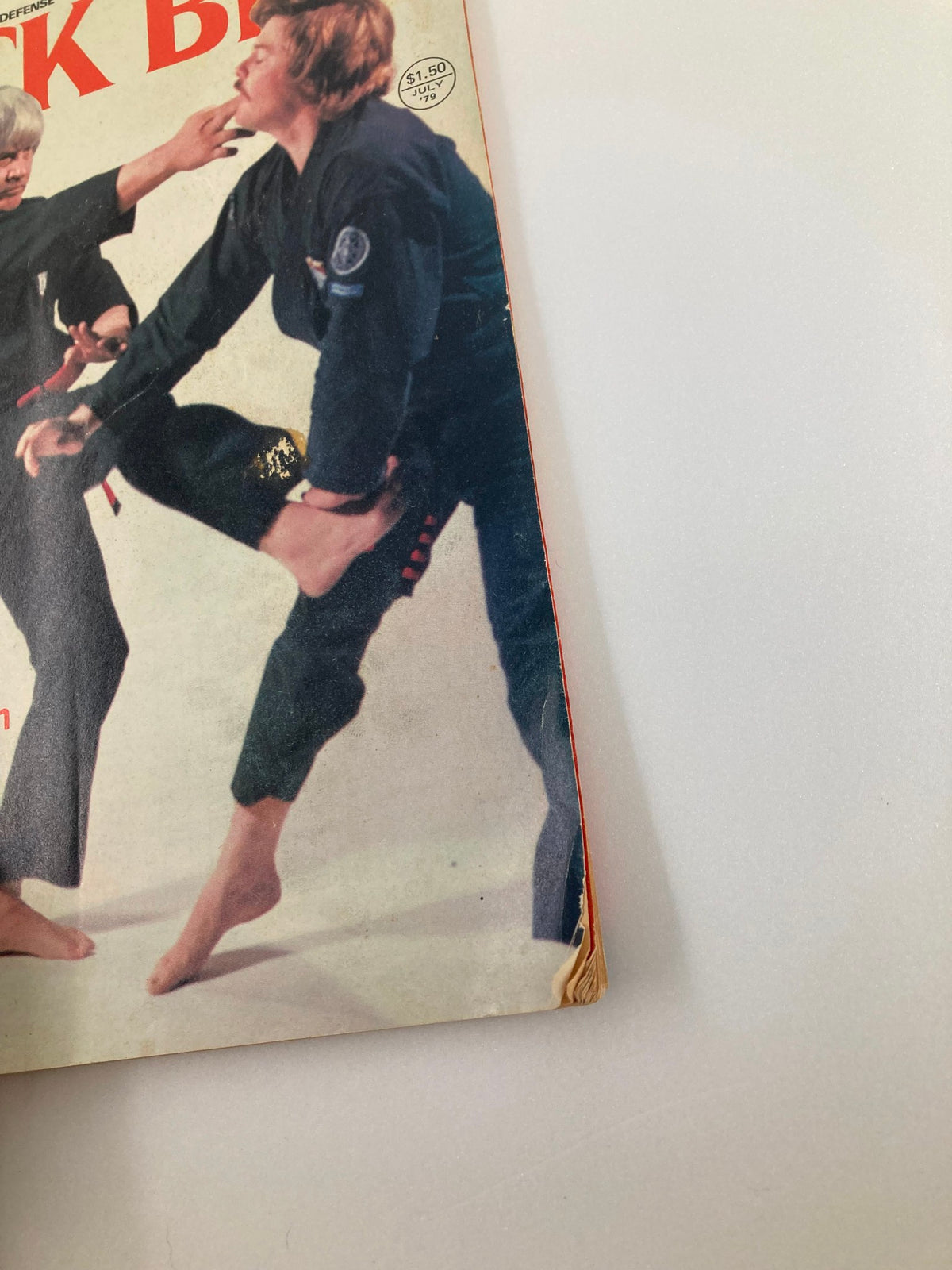 Detailed view of the cover of VTG Black Belt Magazine July 1979 Vol 17 #7 highlighting Ed Parker and a martial arts demonstration during a combat scene.