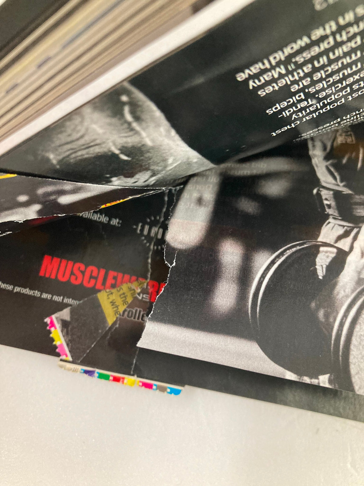 Damaged page from Flex Magazine October 2012 showing minor wear and tear, indicating its pre-owned condition.