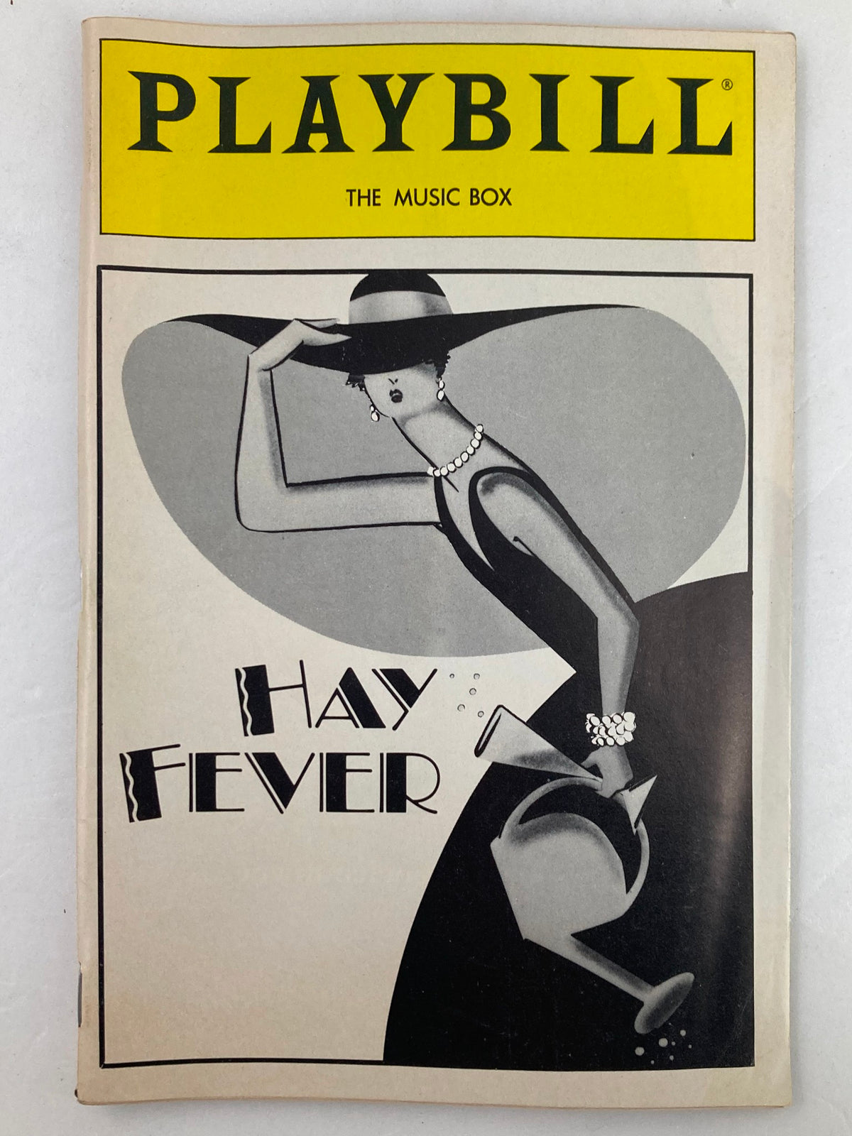 1986 Playbill for The Music Box featuring Hay Fever, showcasing a stylish vintage design with a female figure elegantly dressed and striking a pose.