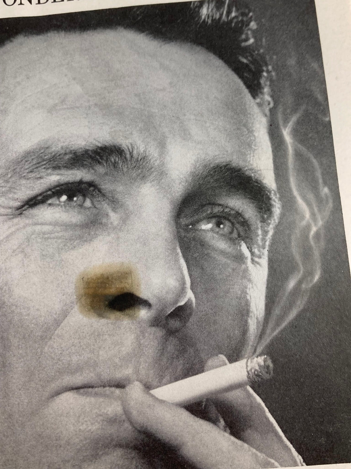 Close-up photograph of Peter Ustinov, featured in the 1958 Playbill for The Plymouth Theatre in 'Romanoff and Juliet,' capturing his intense expression while smoking.