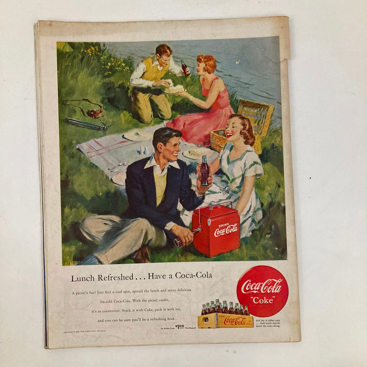 Coca-Cola advertisement in Saturday Evening Post Magazine July 16 1949 depicting a picnic scene with friends enjoying drinks on a sunny day.