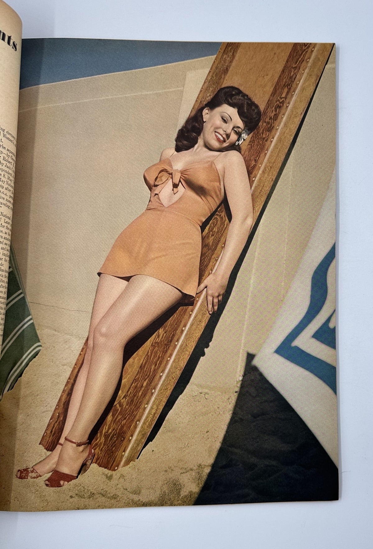 Page from Esquire Magazine July 1944 featuring a photograph of a smiling woman in a stylish bathing suit, posing confidently with a beach backdrop.