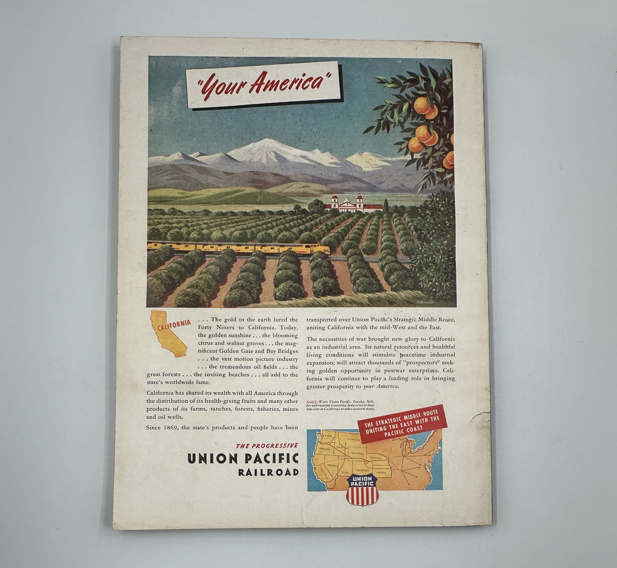 Esquire Magazine December 1945 featuring an advertisement for Union Pacific Railroad, illustrating California's mountainous landscape and orchards, promoting travel in a vintage style.