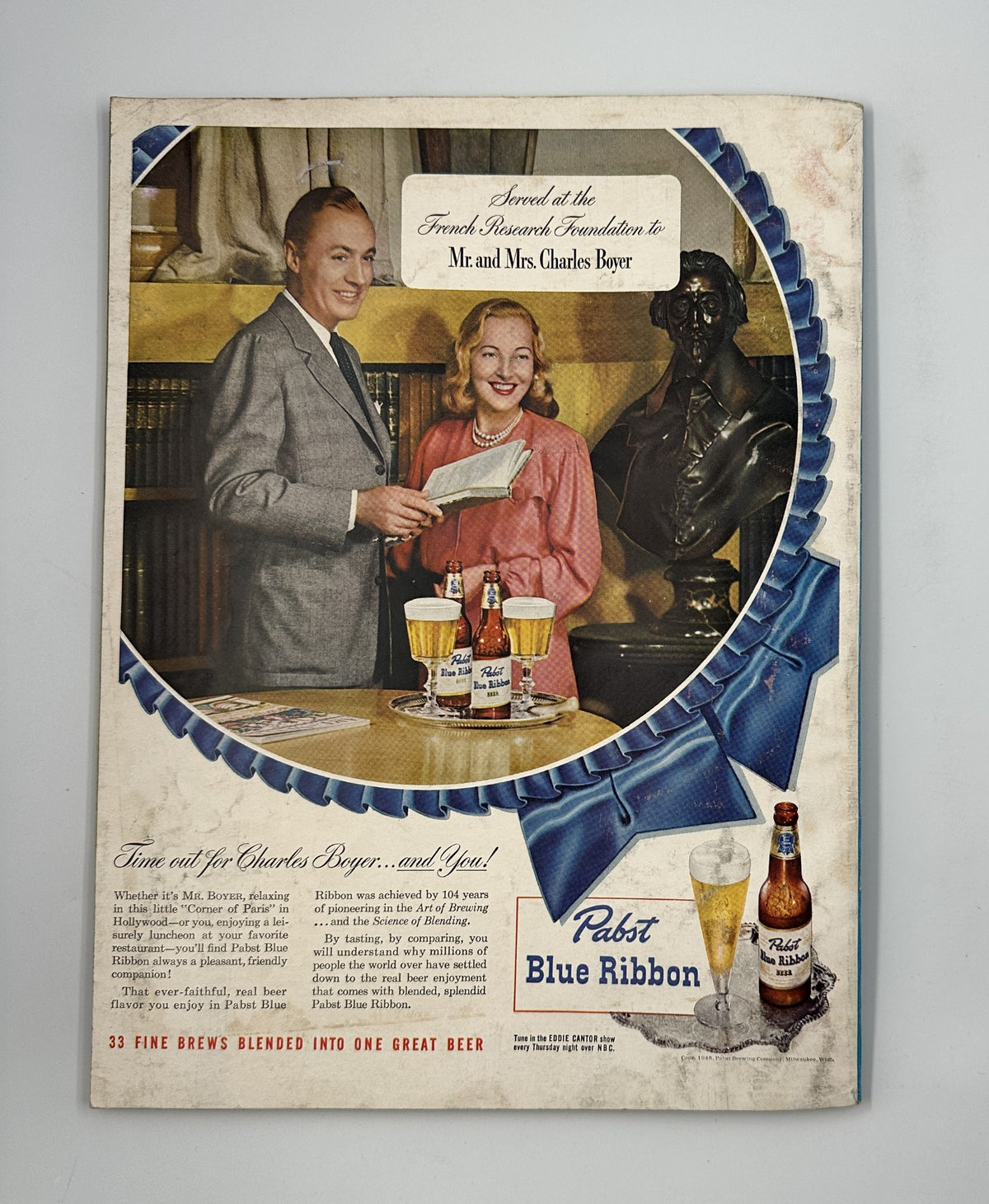 Esquire Magazine May 1948 back cover advertisement for Pabst Blue Ribbon beer, depicting a couple enjoying drinks in a vintage setting.
