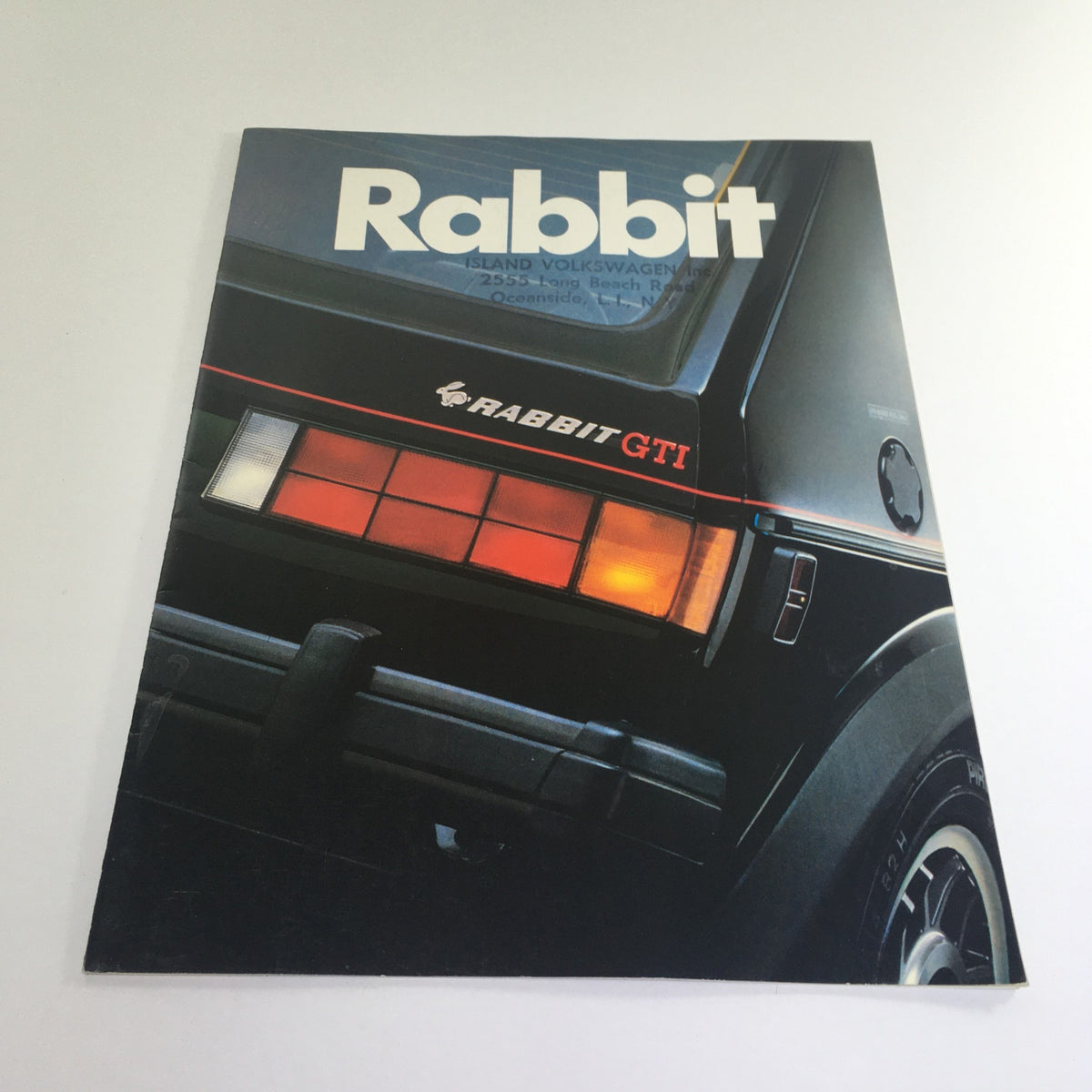 1983 Volkswagen Rabbit GTI GL Dealership Car Auto Brochure Catalog showcasing the rear view of the vehicle with emphasis on the 'RABBIT GTI' emblem and tail lights.
