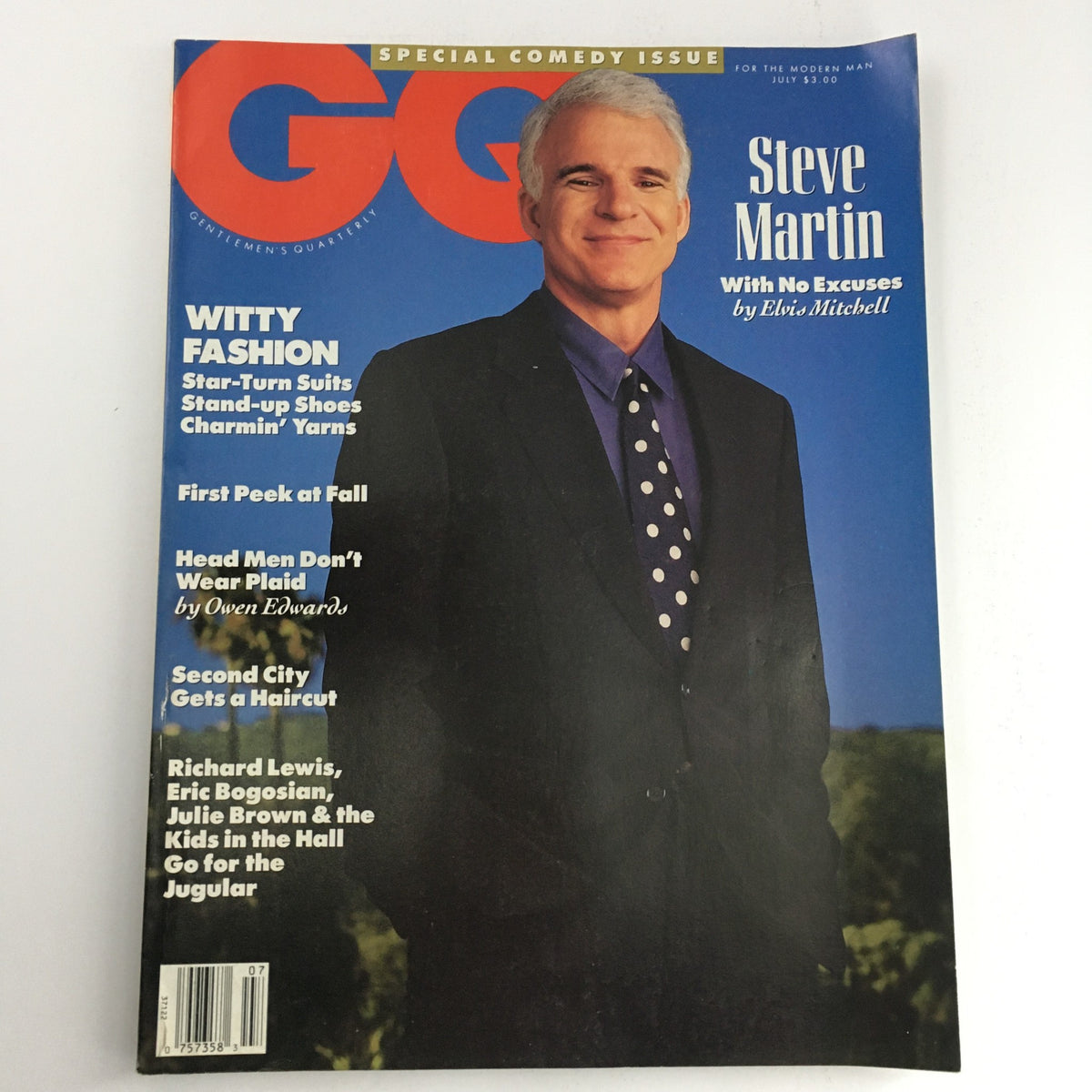 GQ Magazine July 1990 featuring Steve Martin on the cover as part of a special comedy issue, with the title "No Excuses" by Elvis Mitchell. The magazine showcases a modern man in stylish attire.