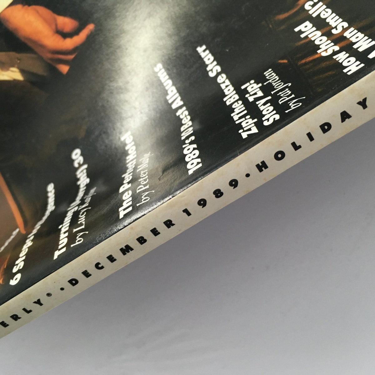 Close-up of the spine of GQ Magazine December 1989 showcasing the publication date and details for collectors.