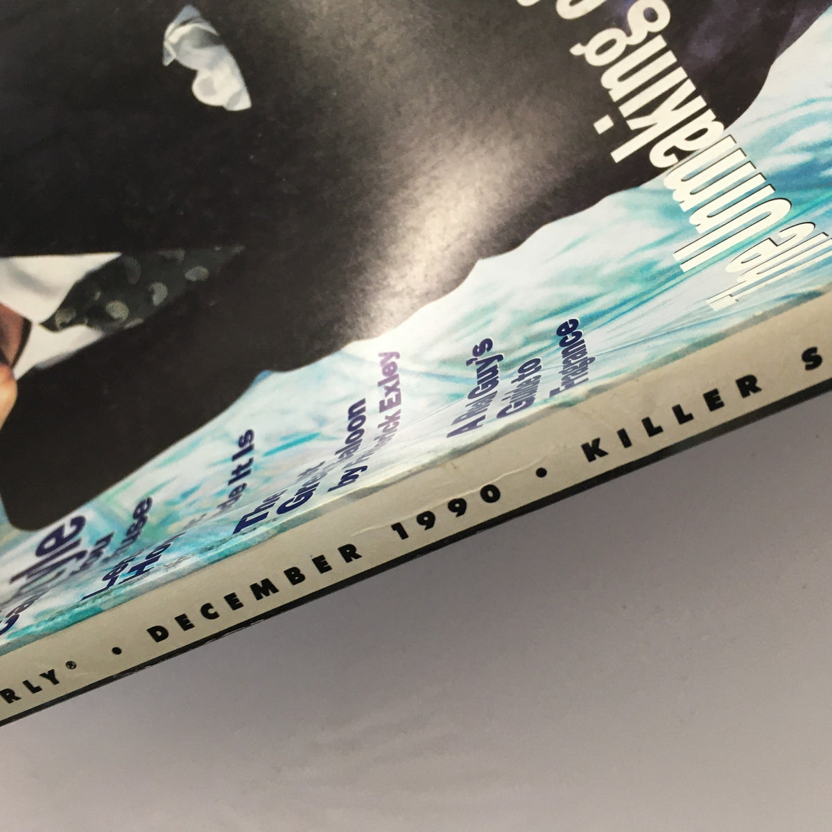 Close-up of the GQ Magazine December 1990 spine, displaying the publication date and features, including 'The Unmaking of Jesse Jackson' and fashion highlights.