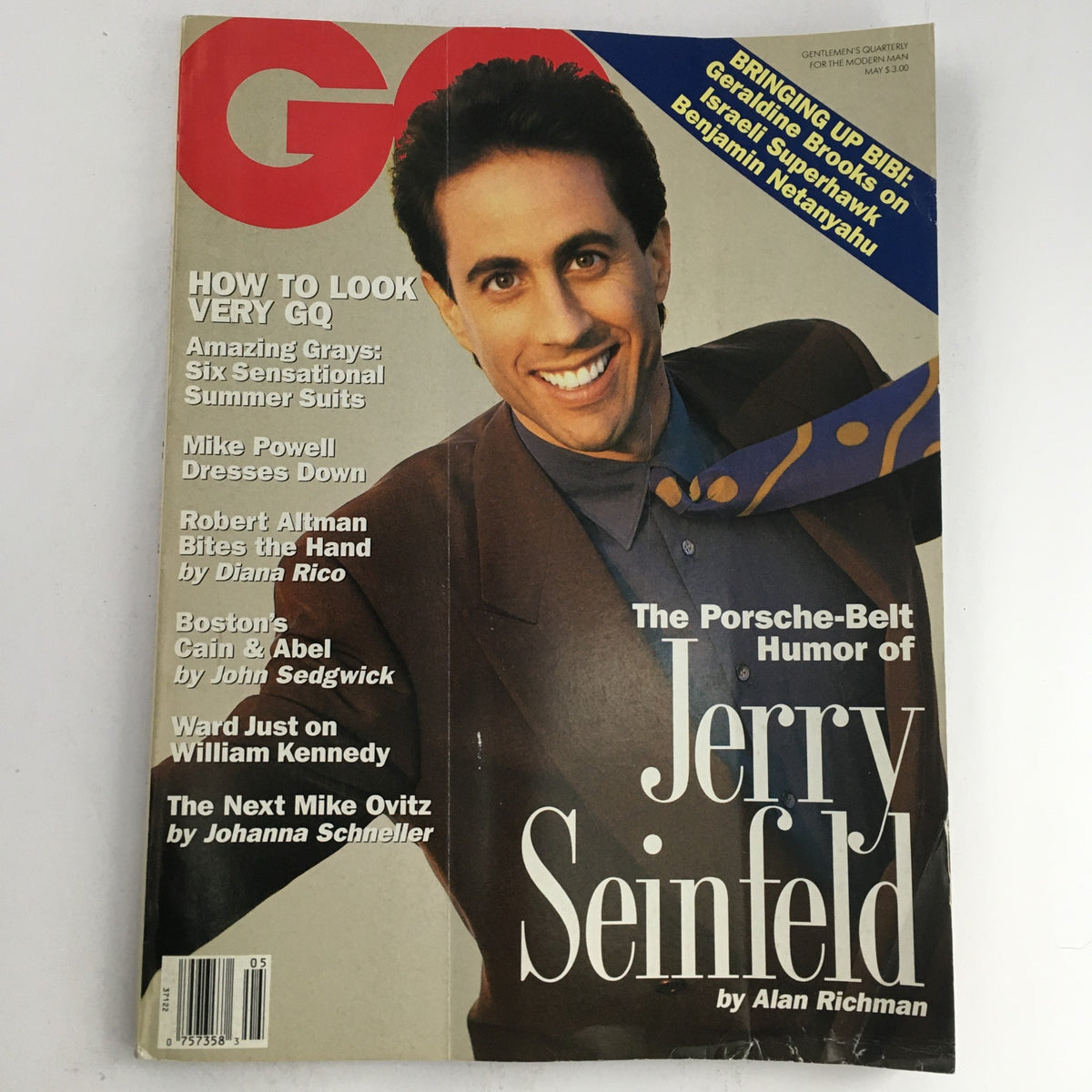 GQ Magazine May 1992 featuring the humor of Jerry Seinfeld on the cover. The magazine presents a portrait of Jerry Seinfeld smiling, dressed in a stylish outfit with a colorful tie, encapsulating '90s fashion and culture.