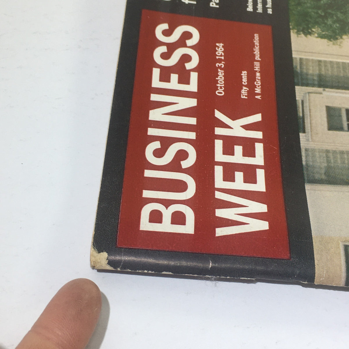 Close-up view of the spine and title of Business Week Magazine, dated October 3, 1964, showing slight wear and tear that adds to its vintage character.