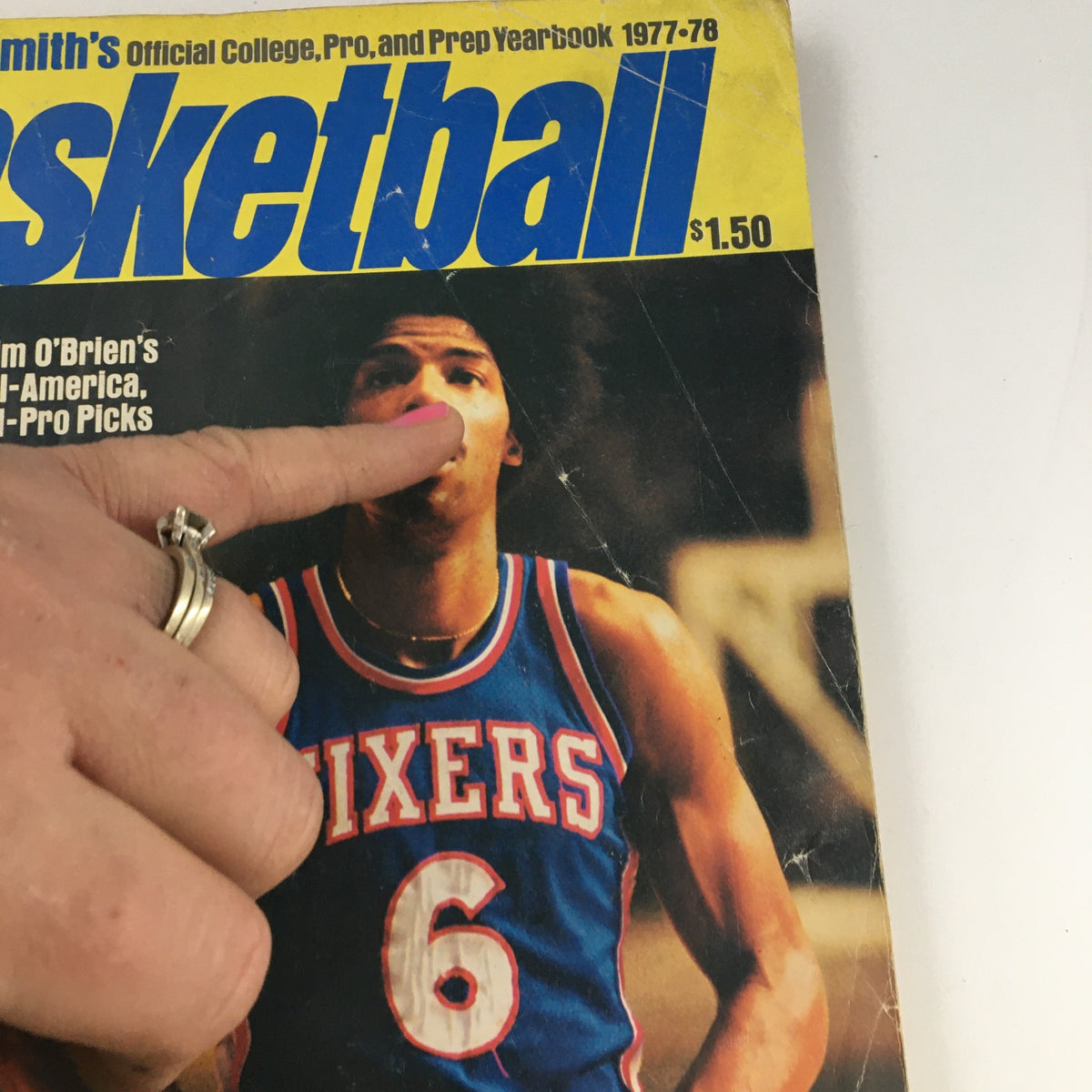 Close-up of Street & Smith's Official College, Pro & Prep Yearbook 1977-1978 cover, focusing on the basketball player wearing a Sixers jersey, emphasizing 'Basketball' and Jim O'Brien's All-America picks.