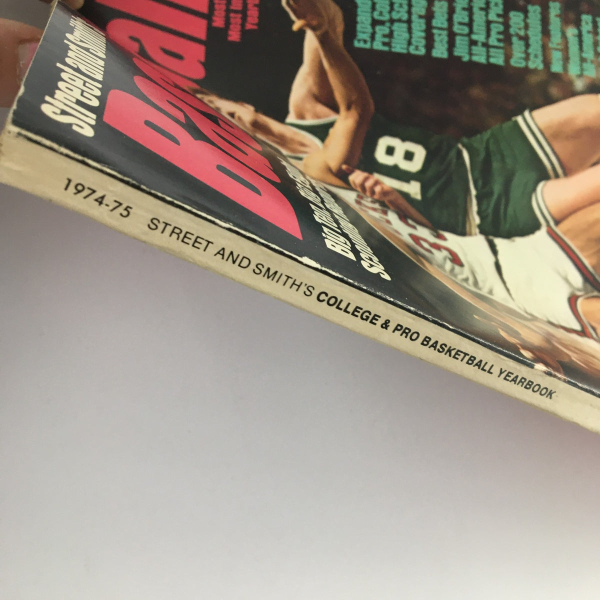 Spine of Street & Smith's College & Pro Basketball Yearbook 1974-75 showing the title and publication date, highlighting its vintage appeal for sports memorabilia enthusiasts.